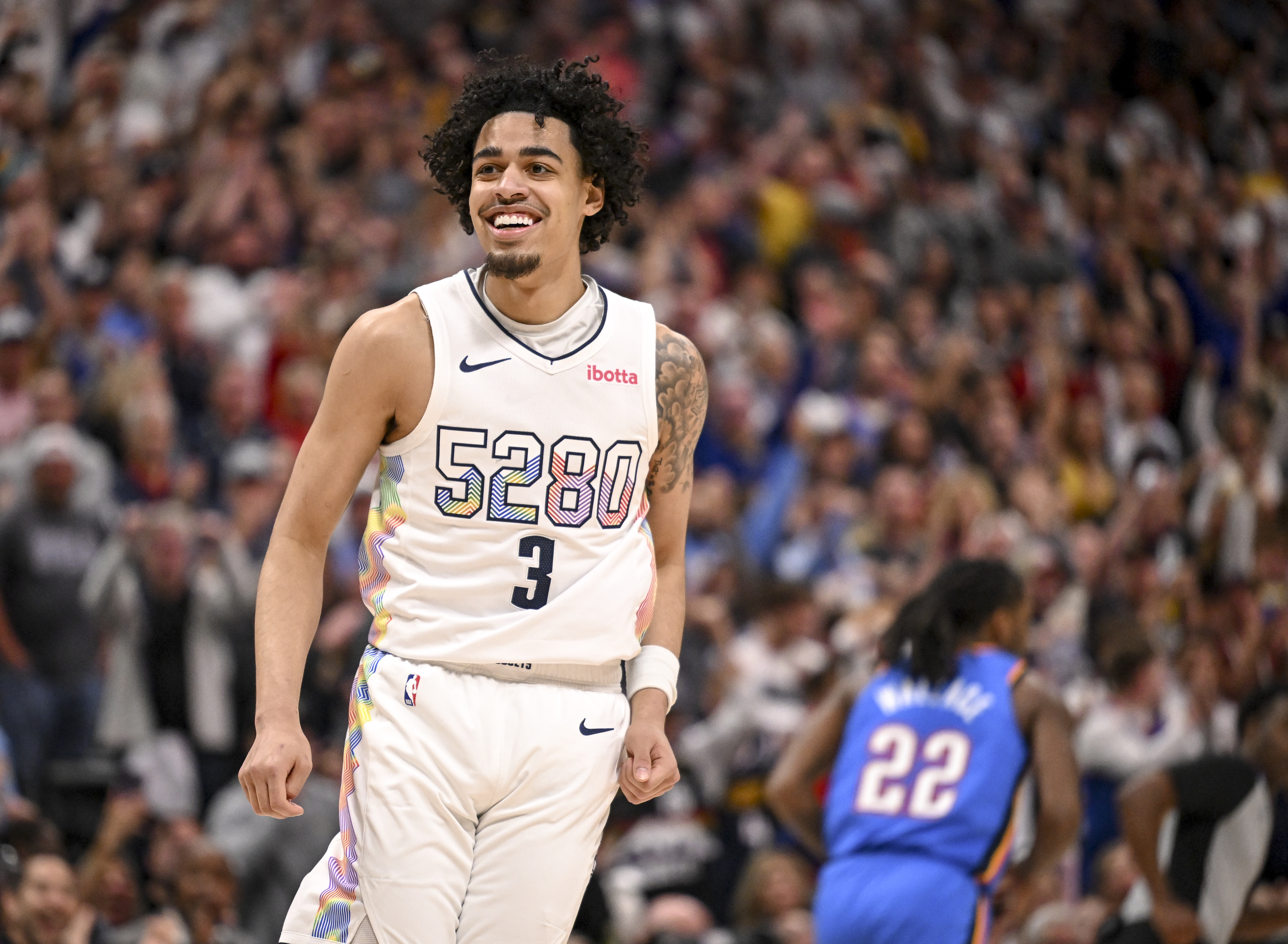 Julian Strawther (3) of the Denver Nuggets smiles after scoring over Shai Gilgeous-Alexander of the Oklahoma City Thunder