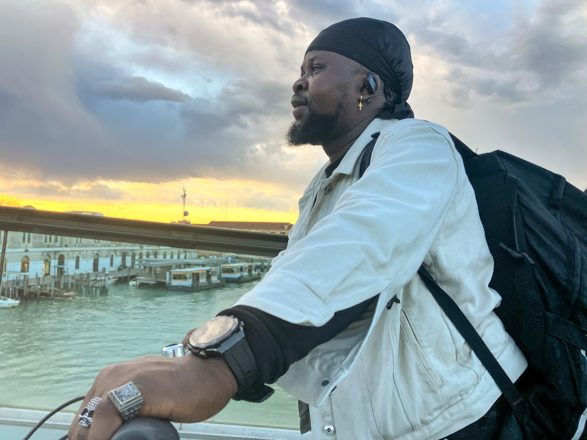 Prince walks his bike across the bridge in Venice to take the bus back to Mestre. [Michela Moscufo/Al Jazeera]