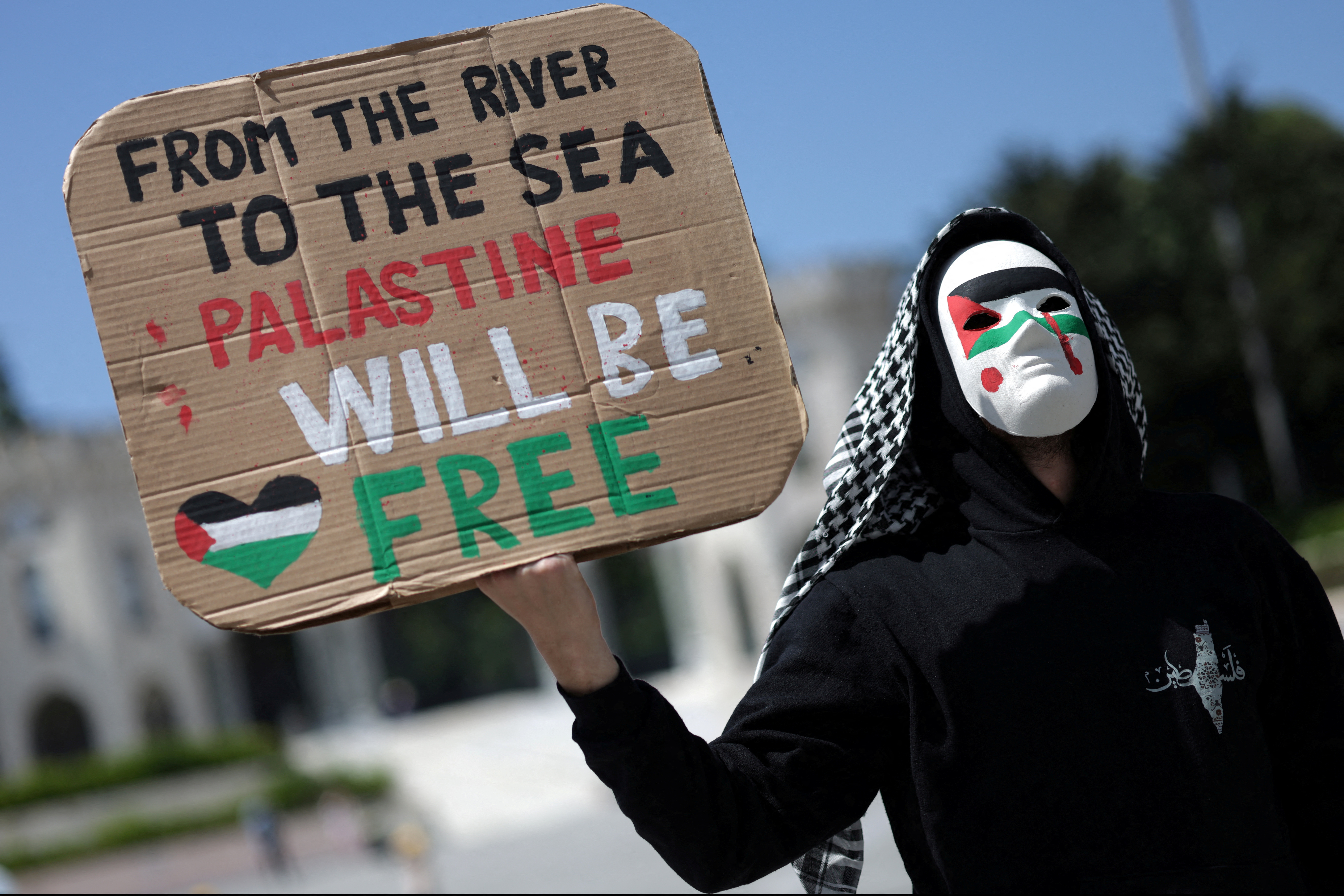 A pro-Palestinian demonstrator holds a placard during a rally to mark the 15th anniversary of the Mavi Marmara Gaza