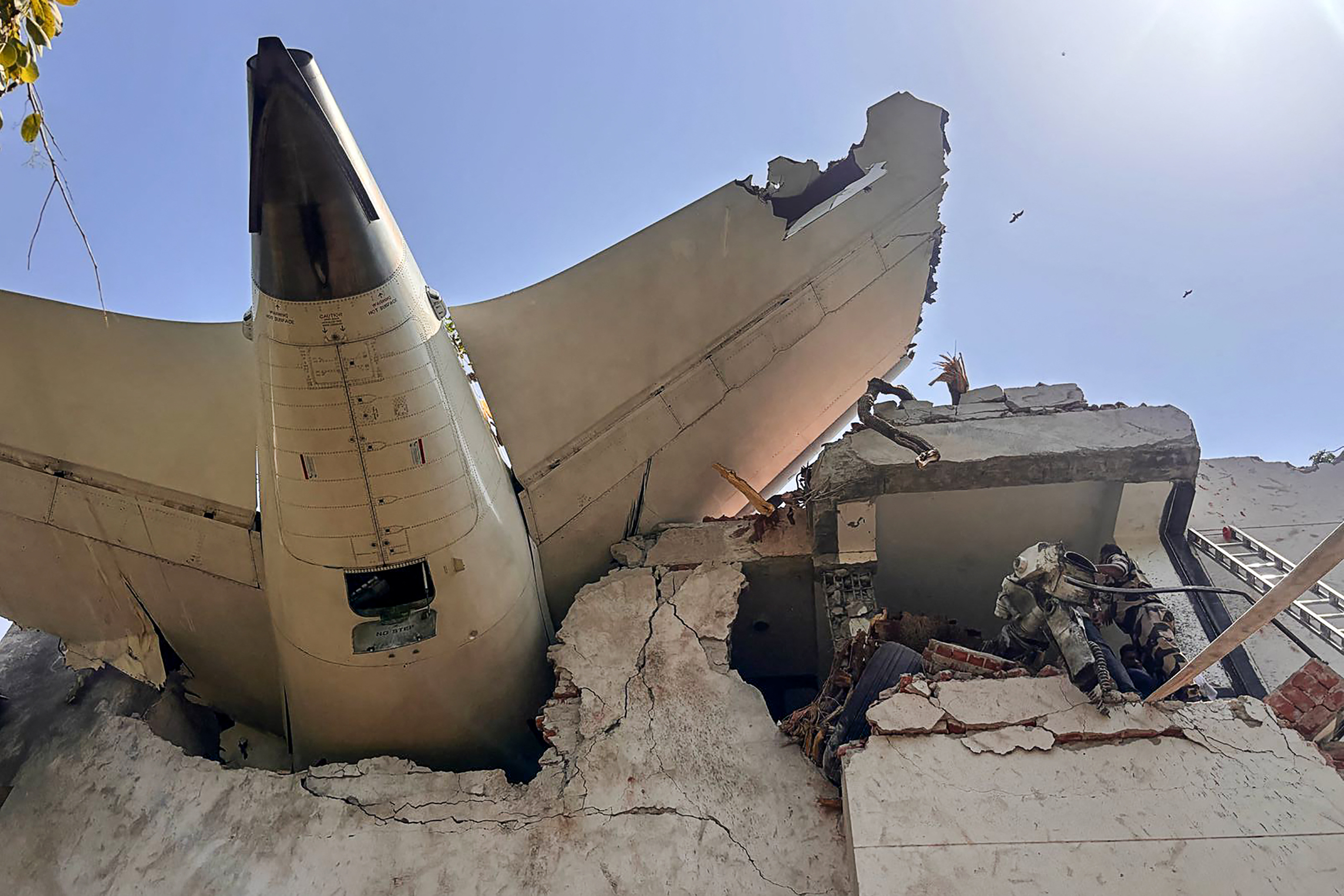 This handout taken and posted on the X account of the Central Industrial Security Force (CISF) On June 12, 2025 shows the back of AN Air India plane after it crashed in a residential area near the airport in Ahmedabad. [Handout/Central Industrial Security Force via AFP]