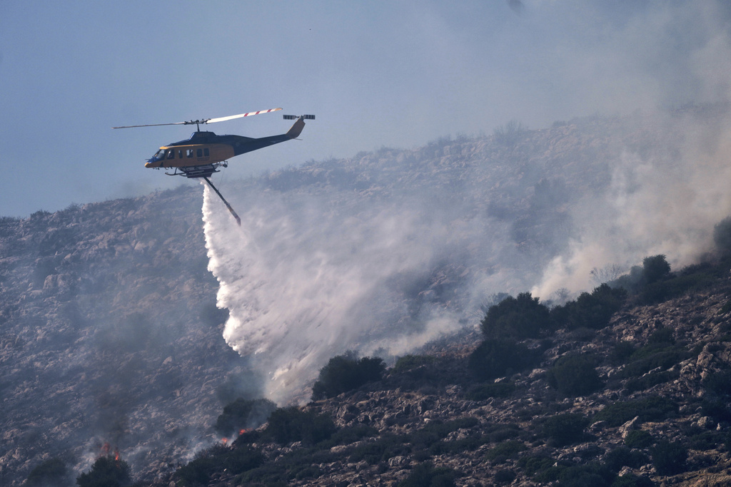 Firefighting helicopter over Charakas, south of Athens, Greece