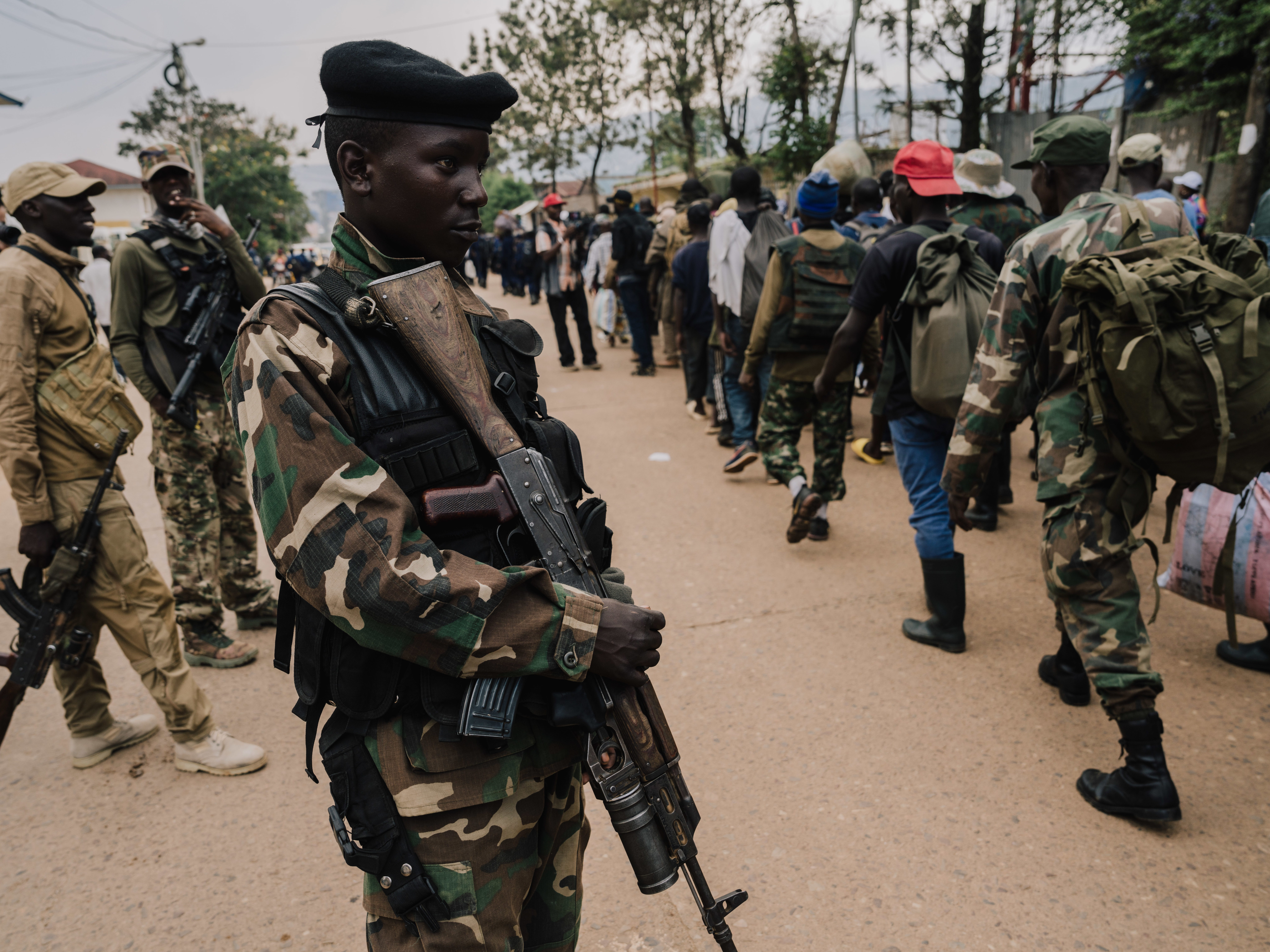 M23 rebels guard a unit of surrendering Congolese military troops.
