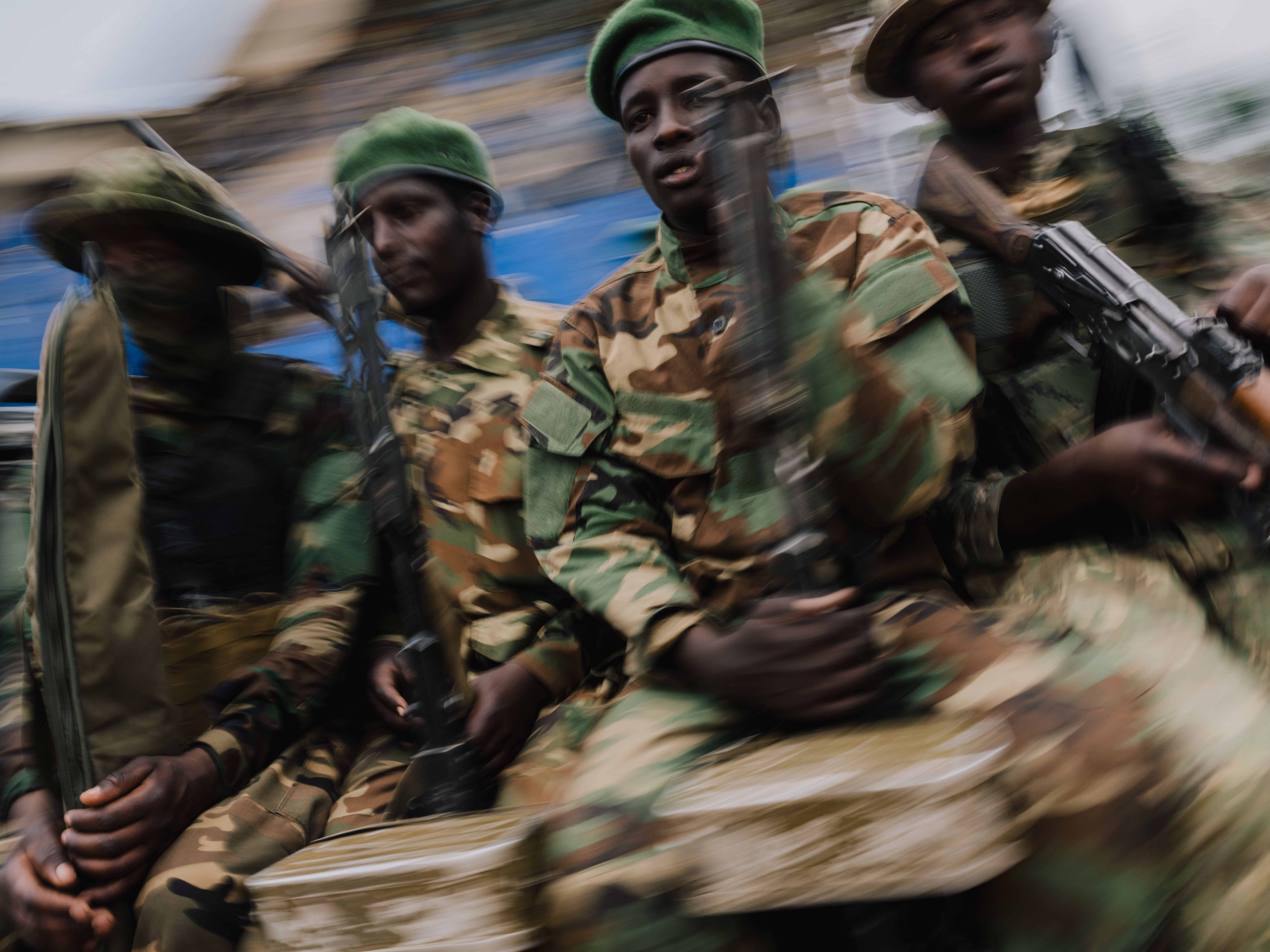M23 rebels guard a unit of surrendering Congolese police officers.