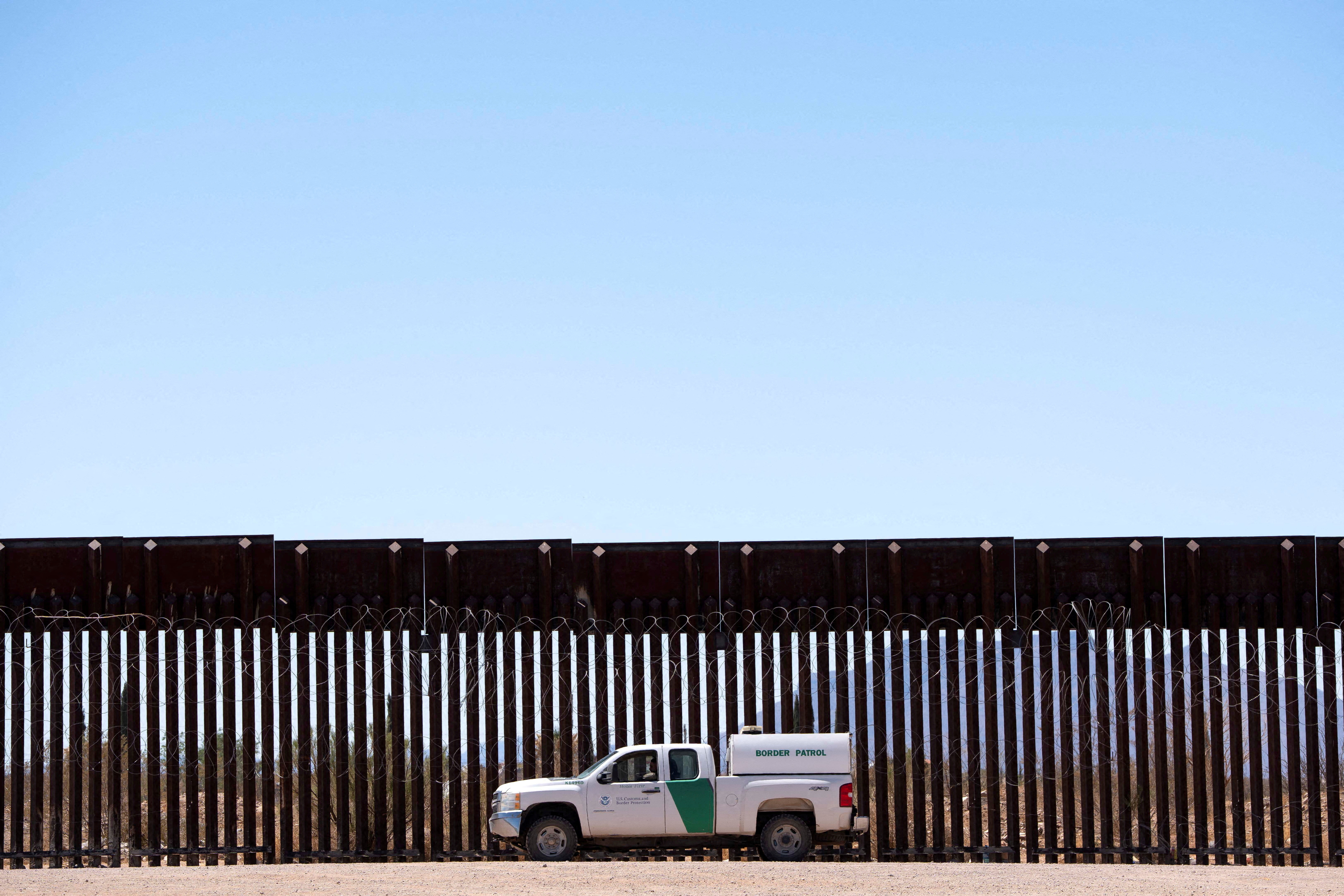 FILE PHOTO: A U.S. Border Patrol agent sits in a vehicle while surveilling a section of the U.S.-Mexico border fence in Douglas, Arizona, U.S., April 20, 2025. REUTERS/Rebecca Noble TPX IMAGES OF THE DAY/File Photo
