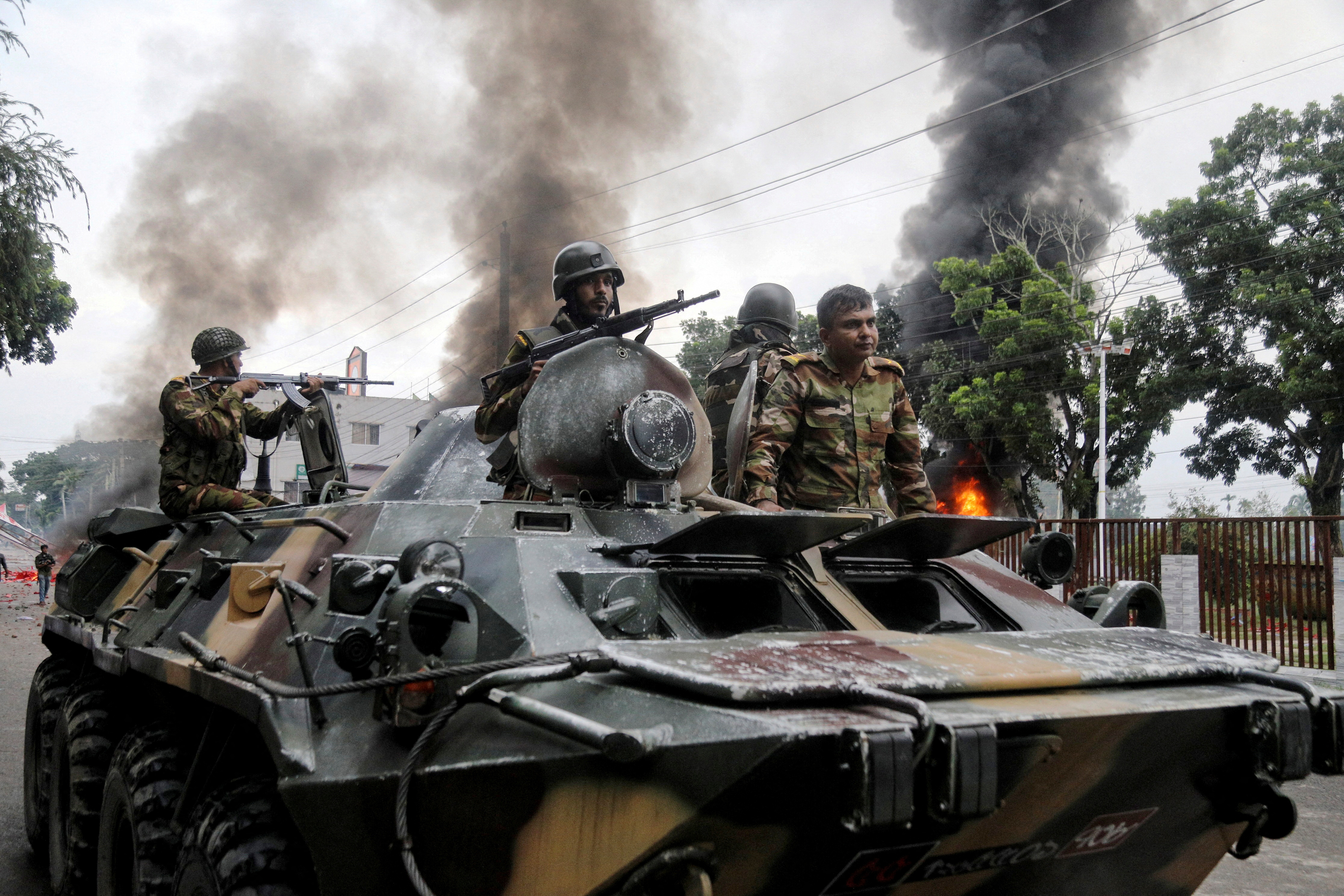 Soldiers sit atop an APC after armed forces were deployed