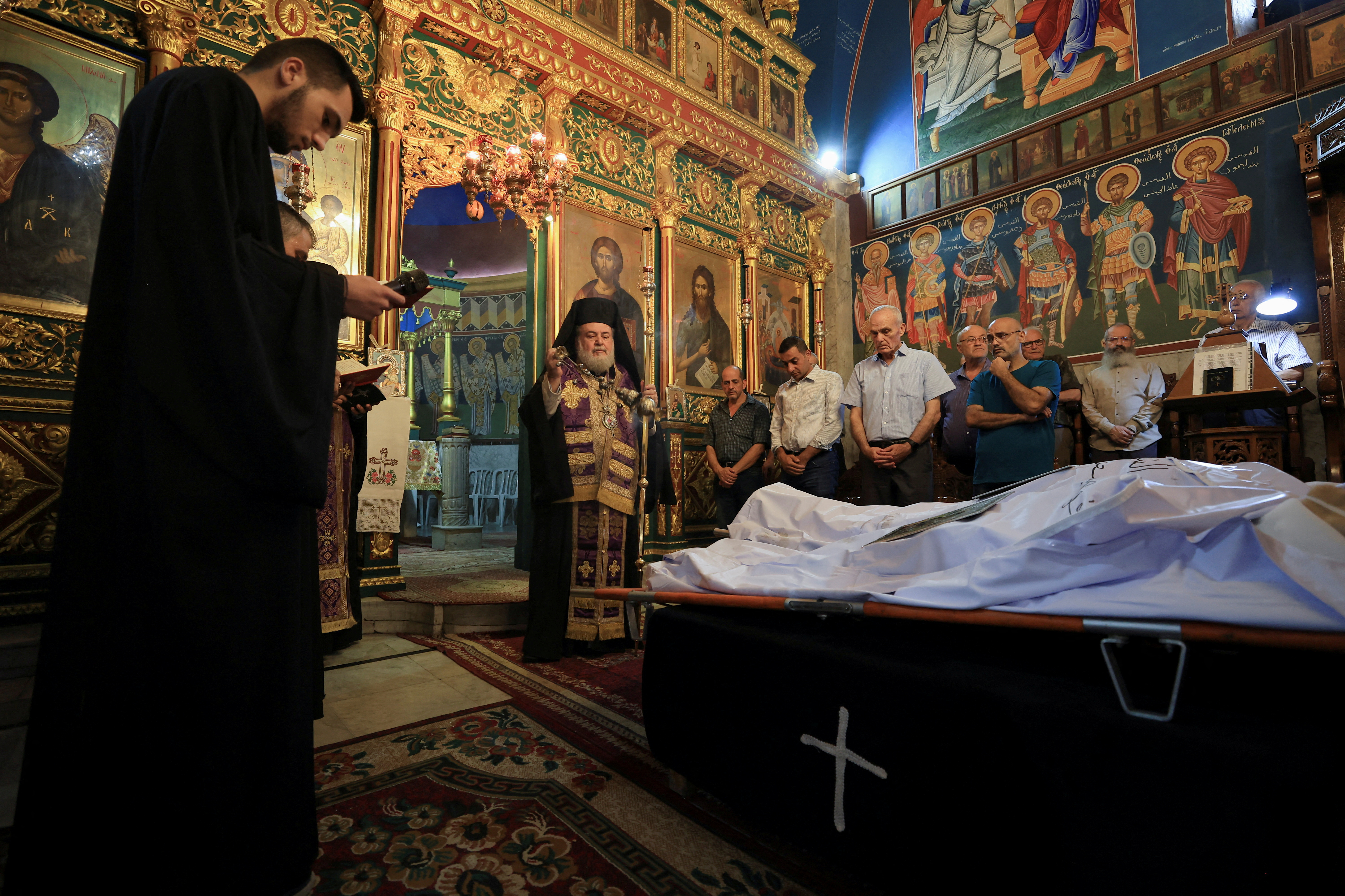 Mourners attend the funeral of two Palestinians killed in Israel's attack on a Gaza City church