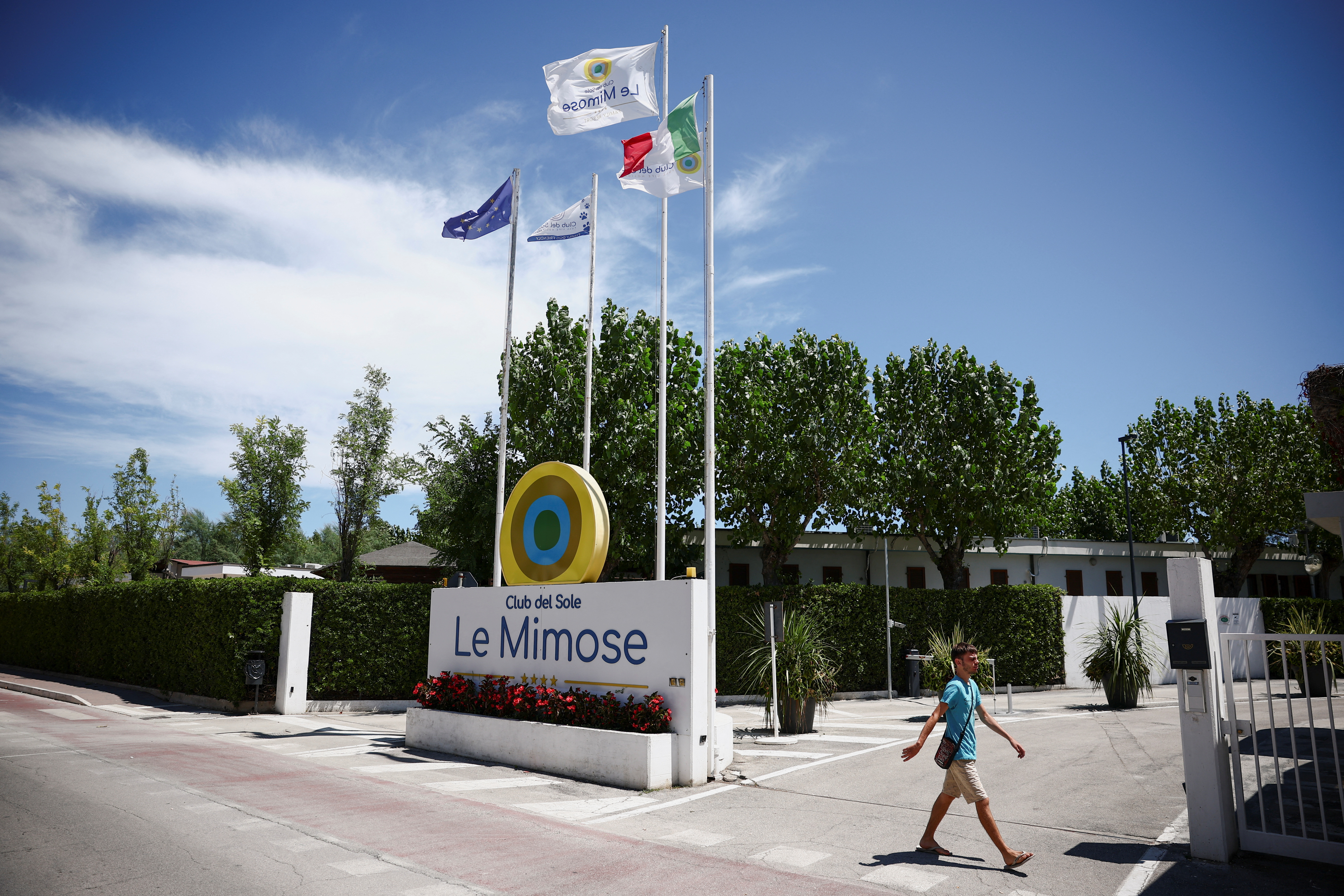 man walks past 'Le Mimose' resort, where skydiver Felix Baumgartner's paraglider crashed, killing him and injuring a hotel employee on the ground, in Porto
