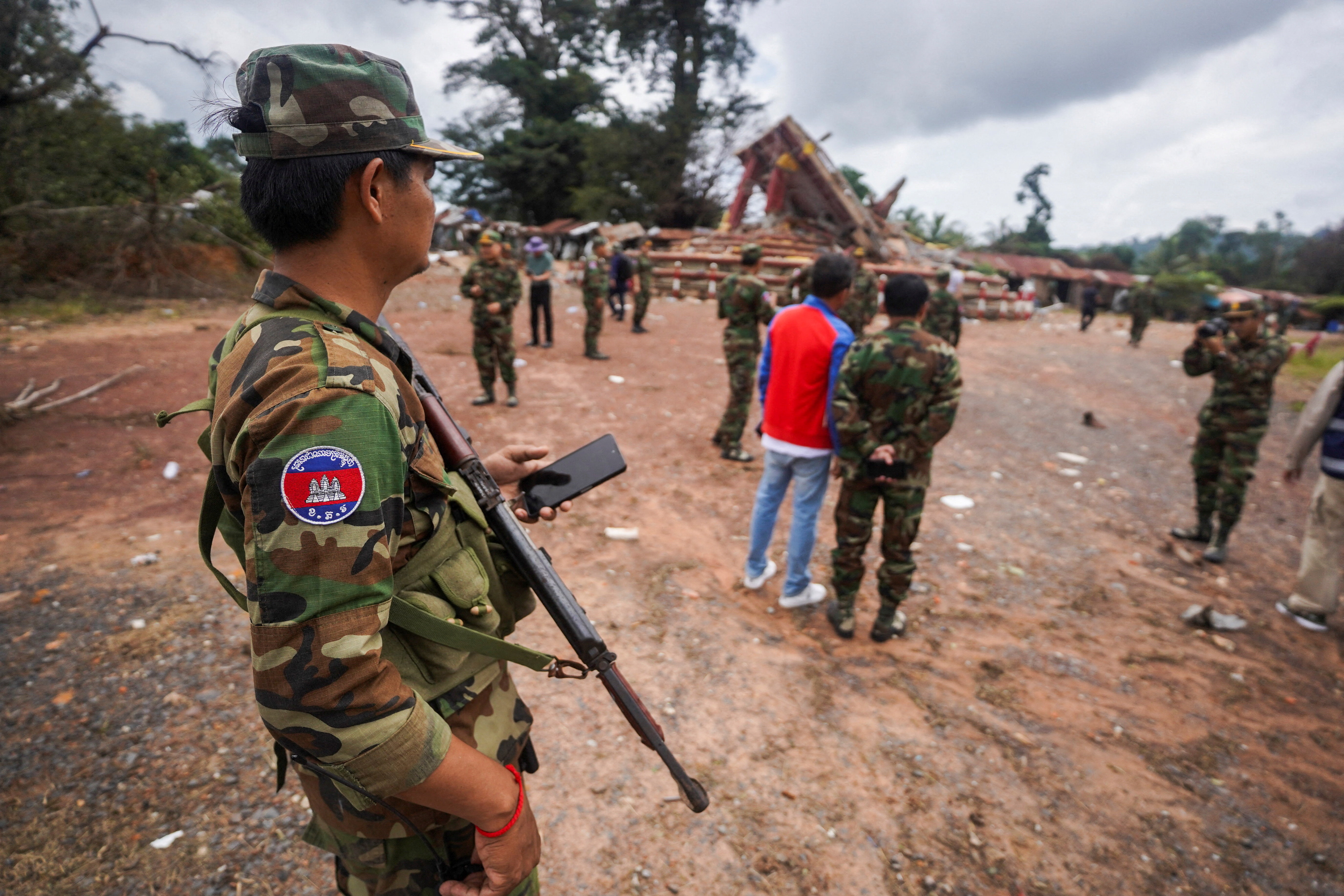 A military personnel takes position at the closed An Ses border checkpoint, also known as Chong Arn Ma in Thai, during an inspection by foreign military attaches from major powers and ASEAN member countries, along with diplomats from 13 countries, after the leaders of Cambodia and Thailand agreed to a ceasefire on Monday effective midnight, in a bid to bring an end to their deadliest conflict in more than a decade, while Thailand's military accuses Cambodia of second ceasefire violation and wait for Cambodia’s invitation for bilateral talks on August 4, Cambodia, July 30, 2025. REUTERS/Soveit Yarn