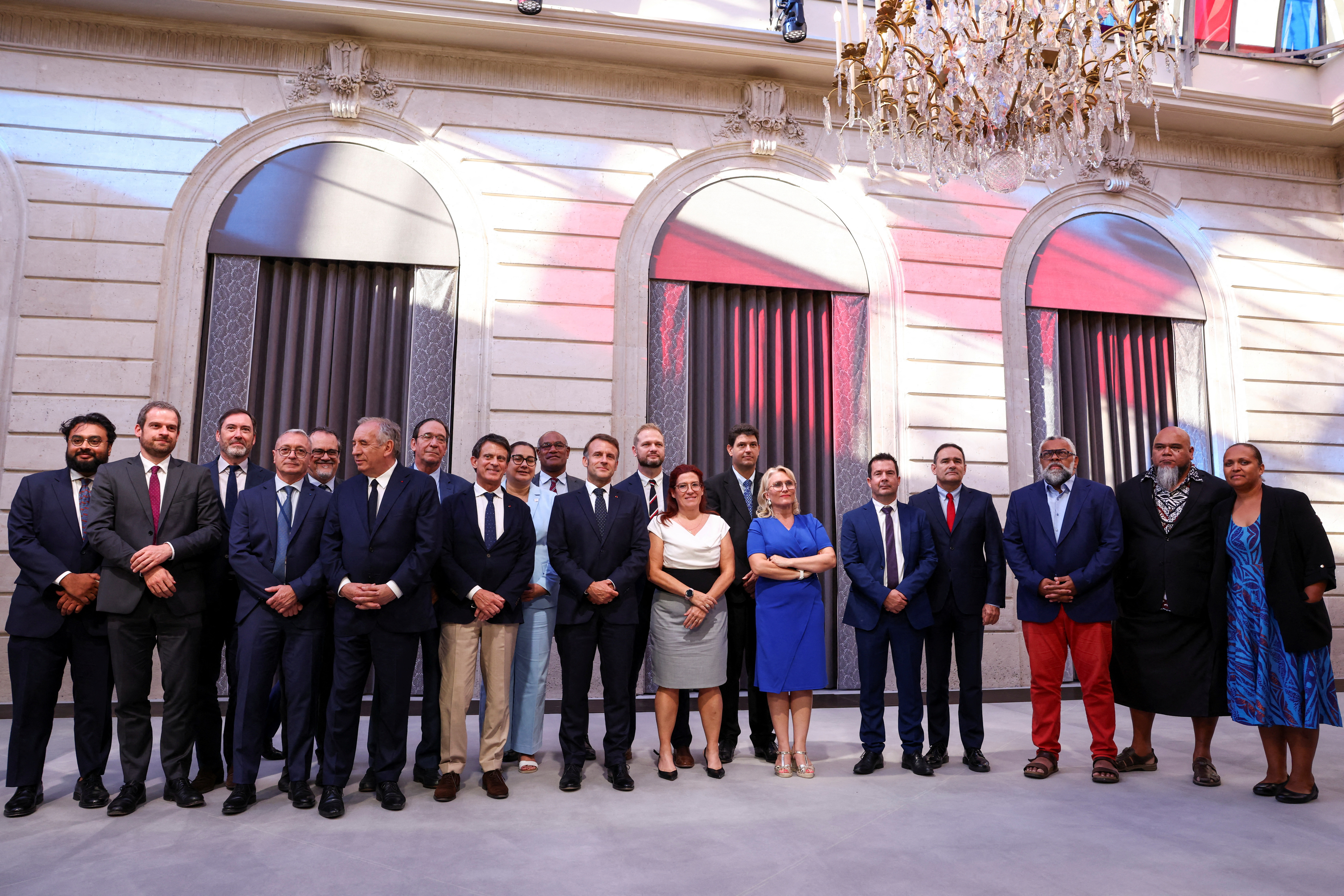 French President Emmanuel Macron and President of the Southern Province Assembly of New Caledonia Sonia Backes (CR) pose with members of the French Government and New Caledonia's elected officials and state representatives