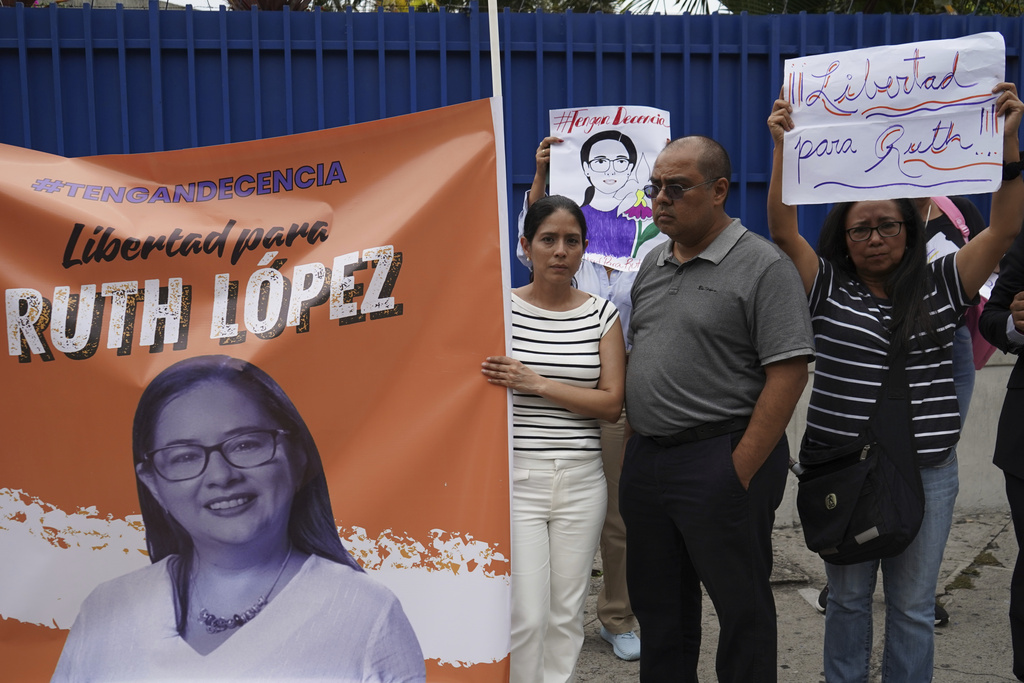 Demonstrators hold a banner showing support for a detained human rights lawyer