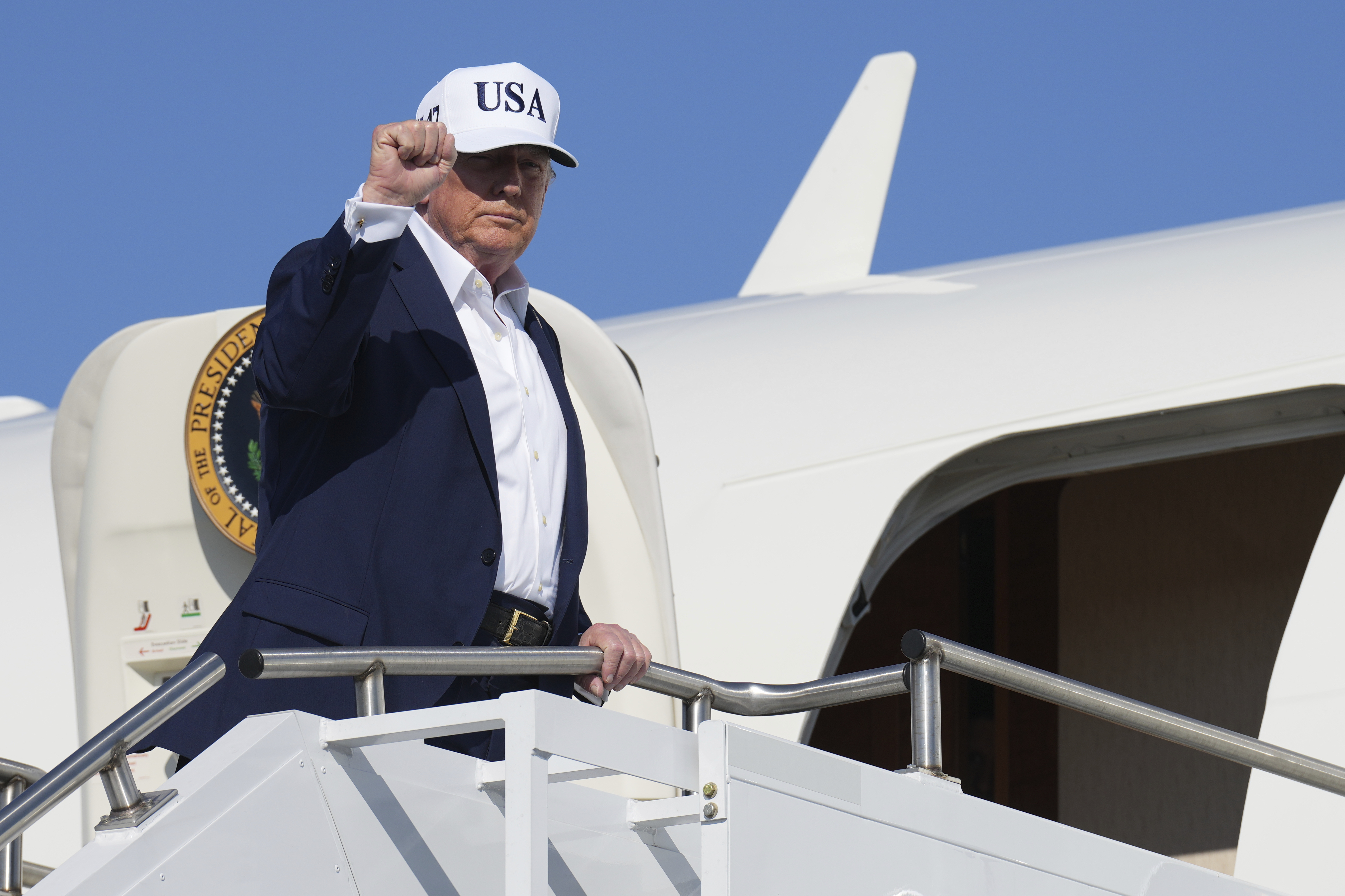 President Donald Trump gestures as he boards Air Force One [Jacquelyn Martin/AP Photo]