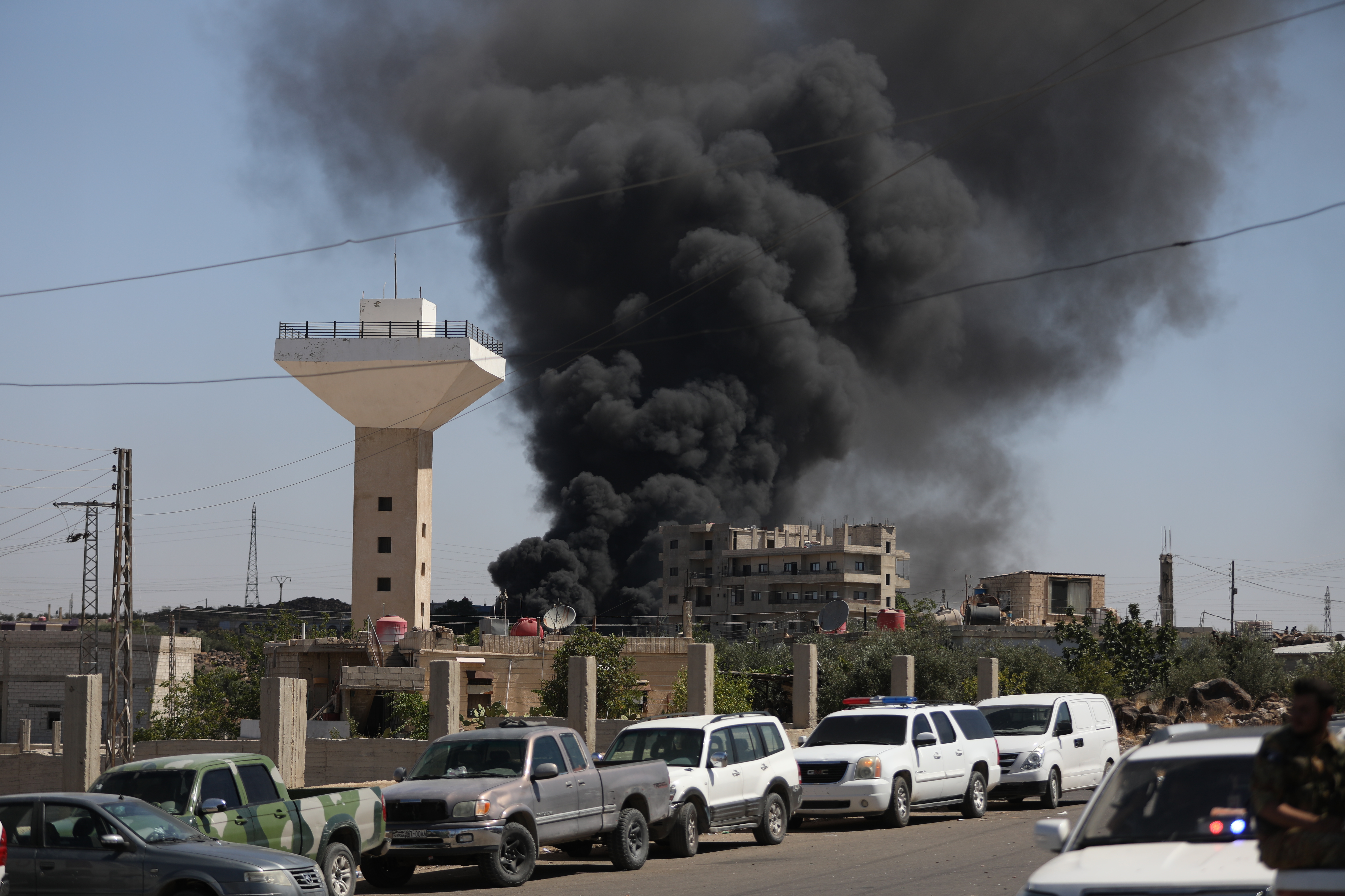 Black smoke billows in the distance on July 15, 2025 near Suwayda, Syria amid clashes in the city