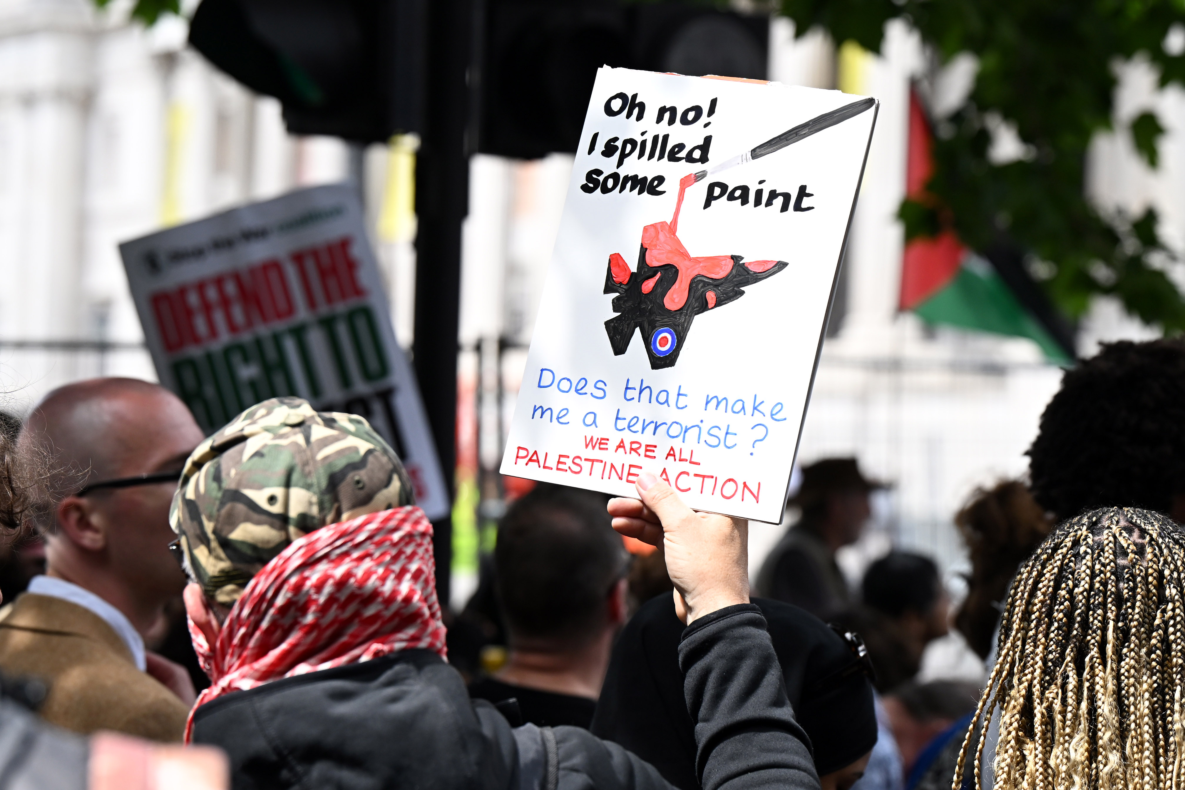 A protester holds a sign during a Palestine Action demonstration at Trafalgar Square at Trafalgar Square in London, England. Members of the Palestine Action (PA) campaign group called an emergency demonstration as Home Secretary Yvette Cooper proscribed the group, making it unlawful to join the organization [File: Leon Neal/Getty Images]