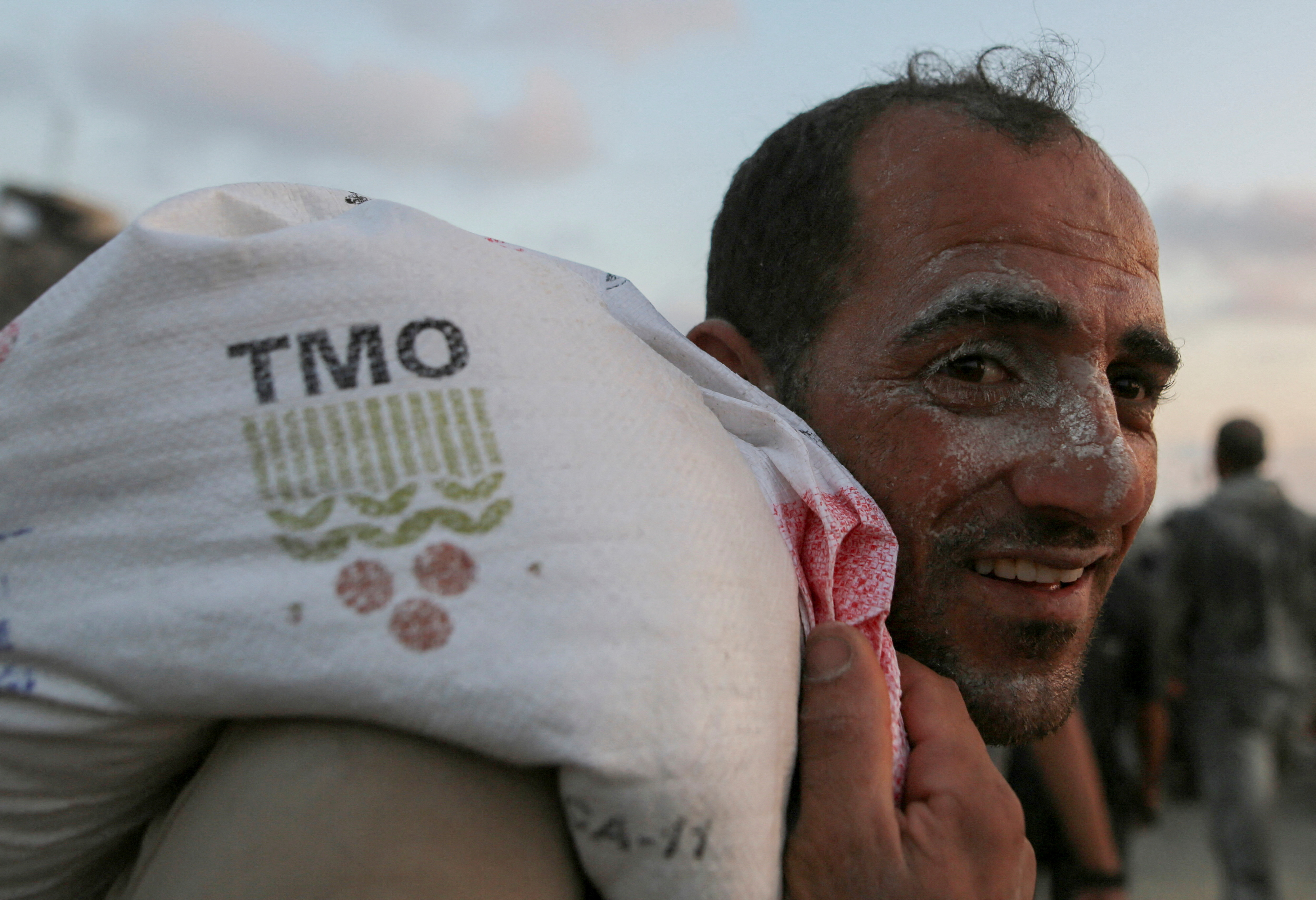 A Palestinian walks carrying aid supplies in Beit Lahia, in the northern Gaza Strip, June 17, 2025. REUTERS/Stringer REFILE - QUALITY REPEAT TPX IMAGES OF THE DAY