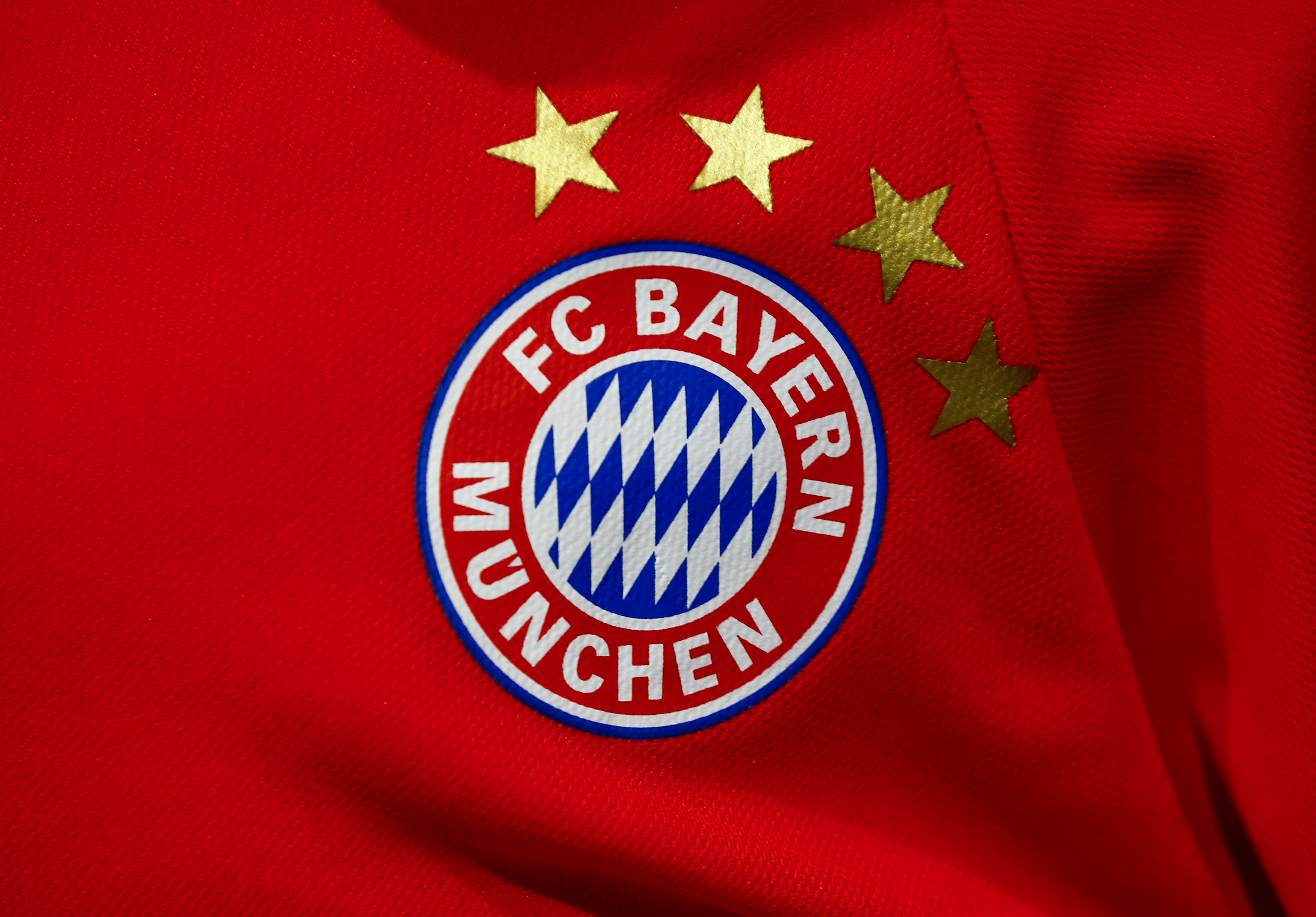 The logo of German first division soccer team Bayern Munich is seen on an official football shirt of Germany's most successful soccer team