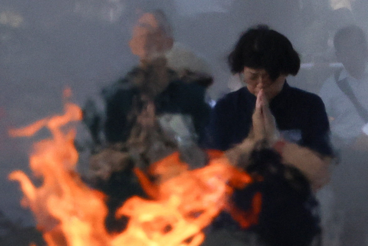 People pray in front of the cenotaph for the victims of the 1945 atomic bombing, at the Peace Memorial Park in Hiroshima western Japan, August 6, 2025 [Kim Kyung-Hoon/Reuters]