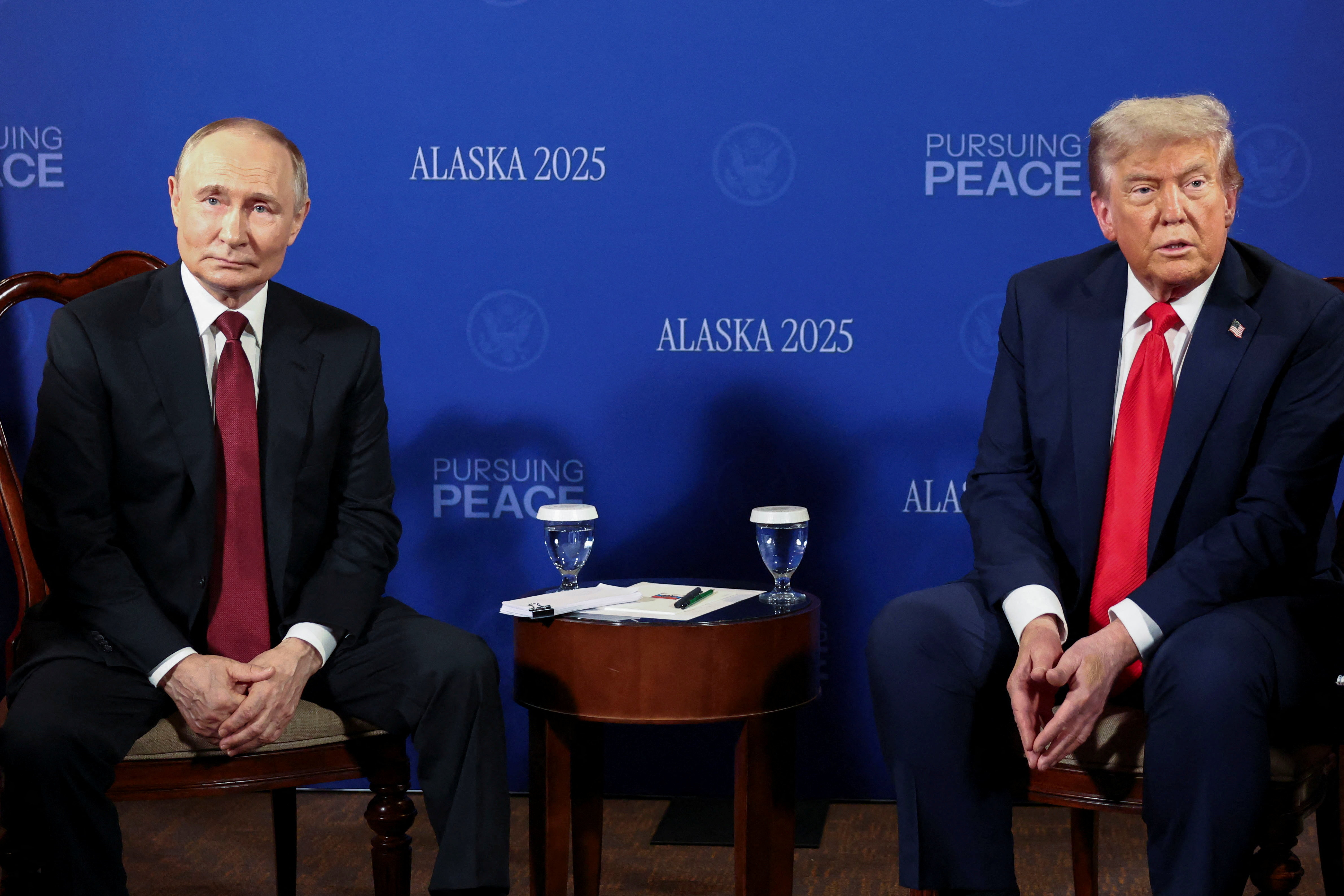 Trump and Putin sit across from each other