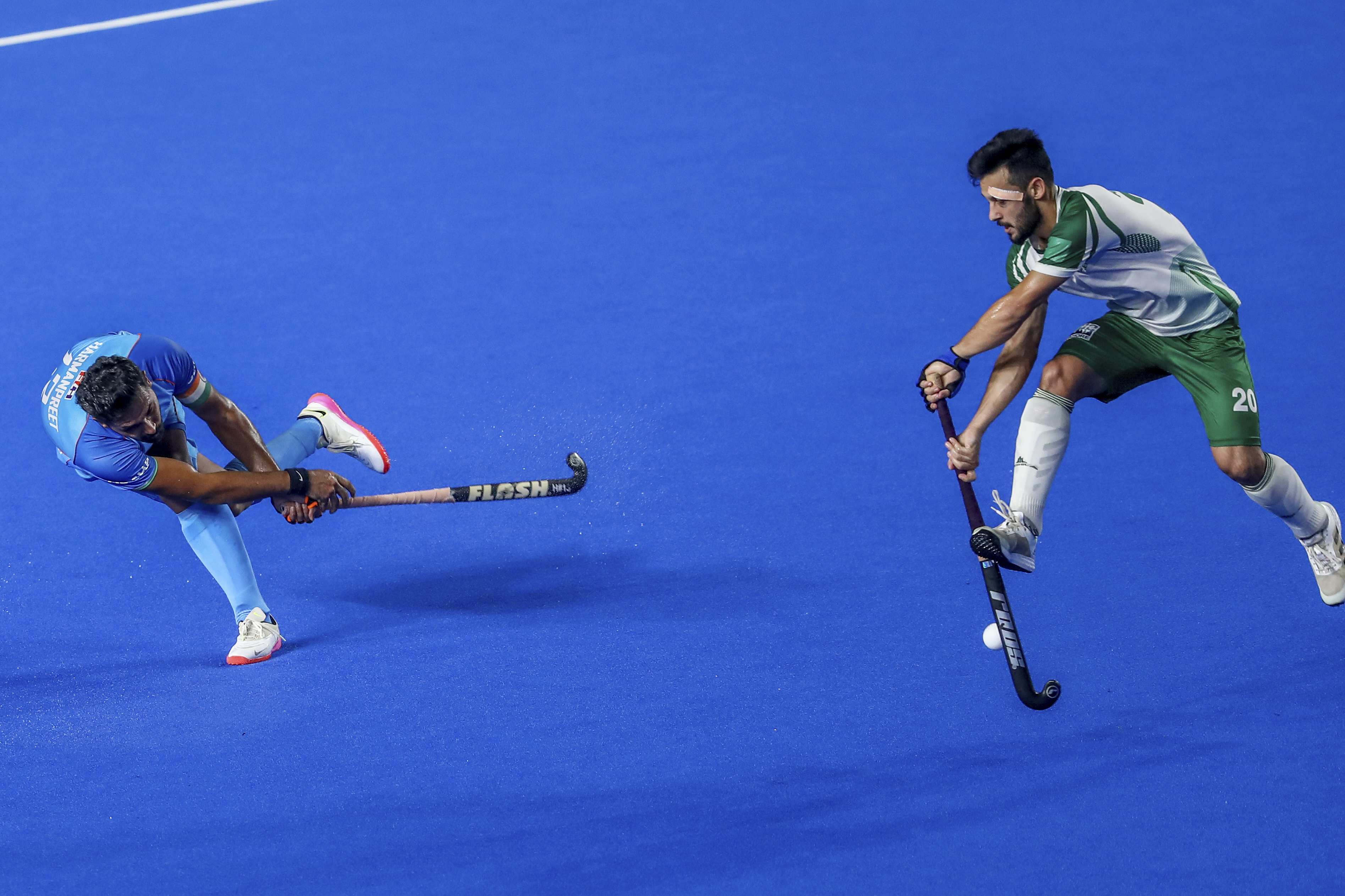 India's captain Harmanpreet Singh, left, is challenged by Pakistan's Afraz during the men's Asian Champions Trophy hockey match between India and Pakistan in Chennai, India, Wednesday, Aug. 9, 2023. (AP Photo/R. Parthibhan)