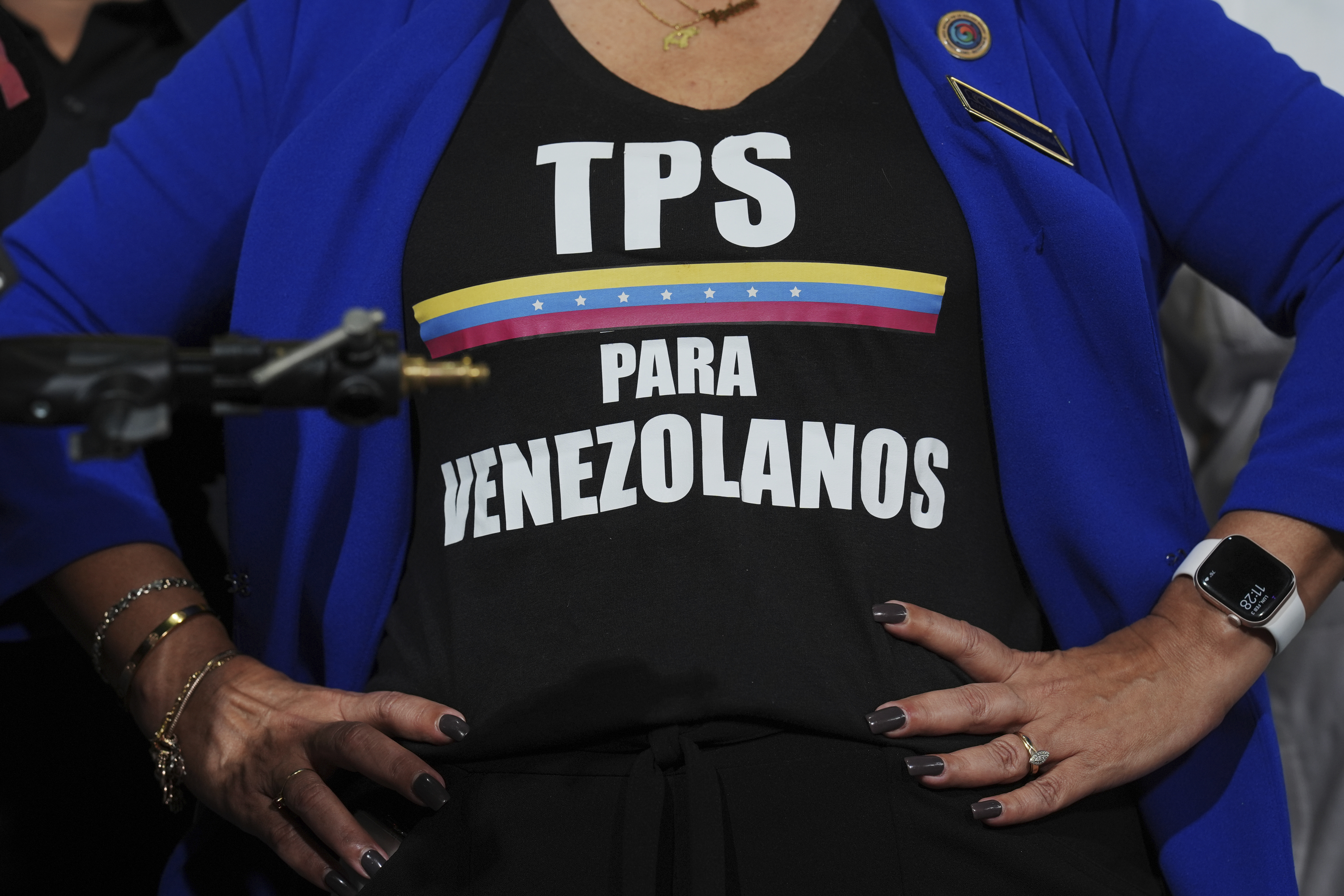 An activist wears a T-shirt calling for Temporary Protected Status for Venezuelans in Doral, Florida. [File: Rebecca Blackwell/The Associated Press]