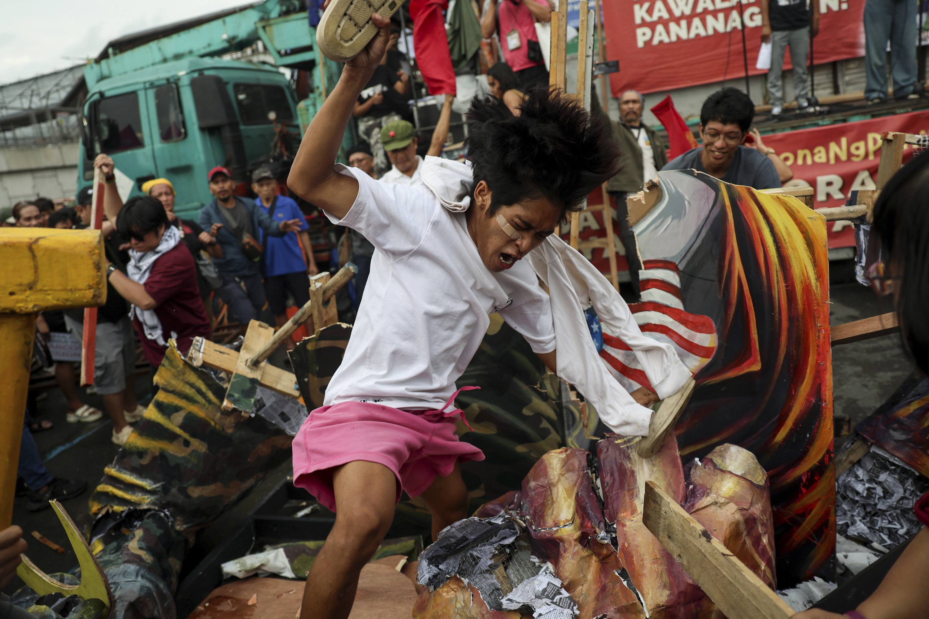 Protesters destroy an effigy of Philippine President Ferdinand Marcos Jr. in time for his State of the Nation Address in Quezon City, Philippines