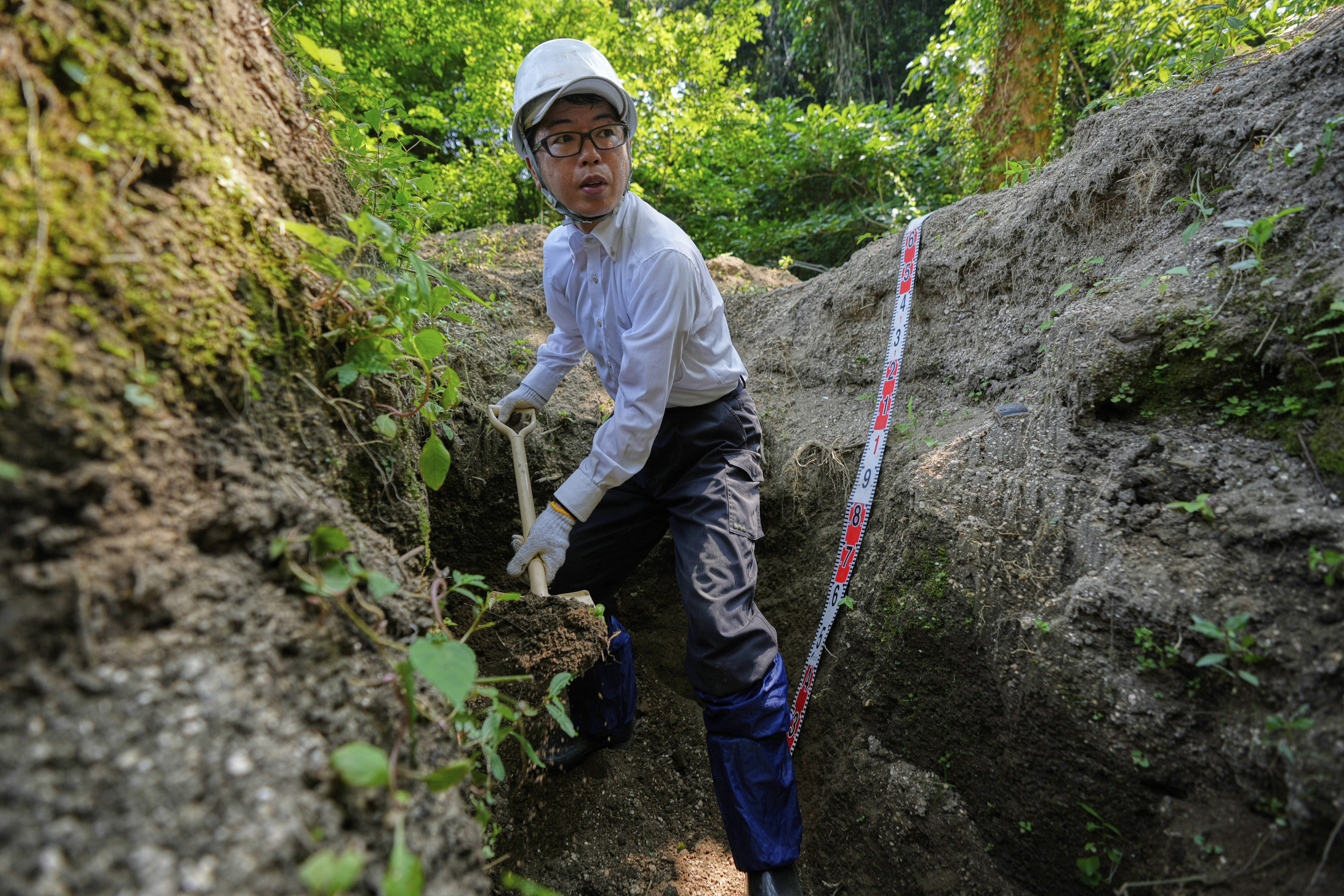 A man searches for remains of victims.