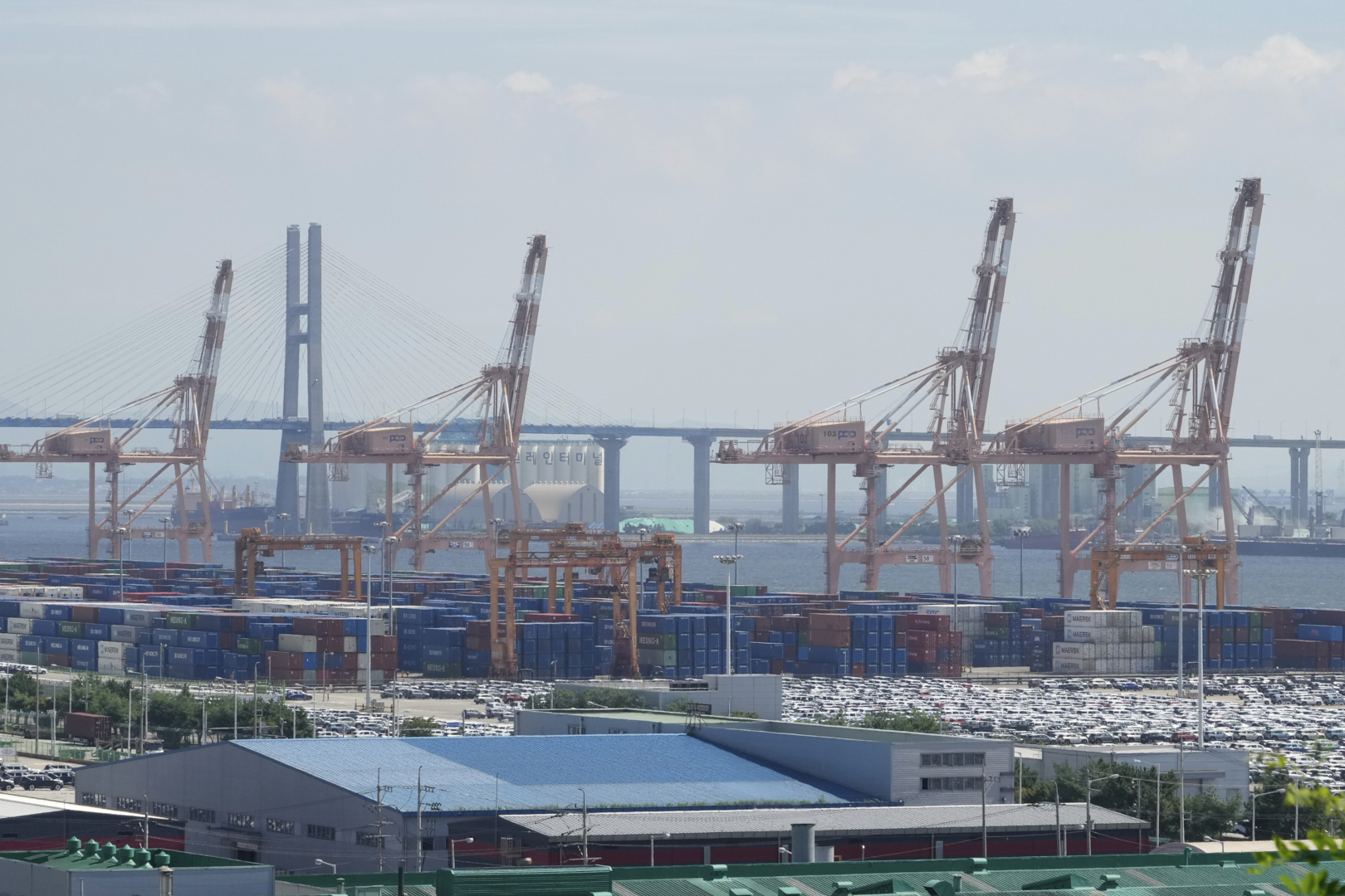 Cranes and shipping containers are seen at a port in Pyeongtaek, South Korea, Thursday, Aug. 7, 2025. (AP Photo/Ahn Young-joon)