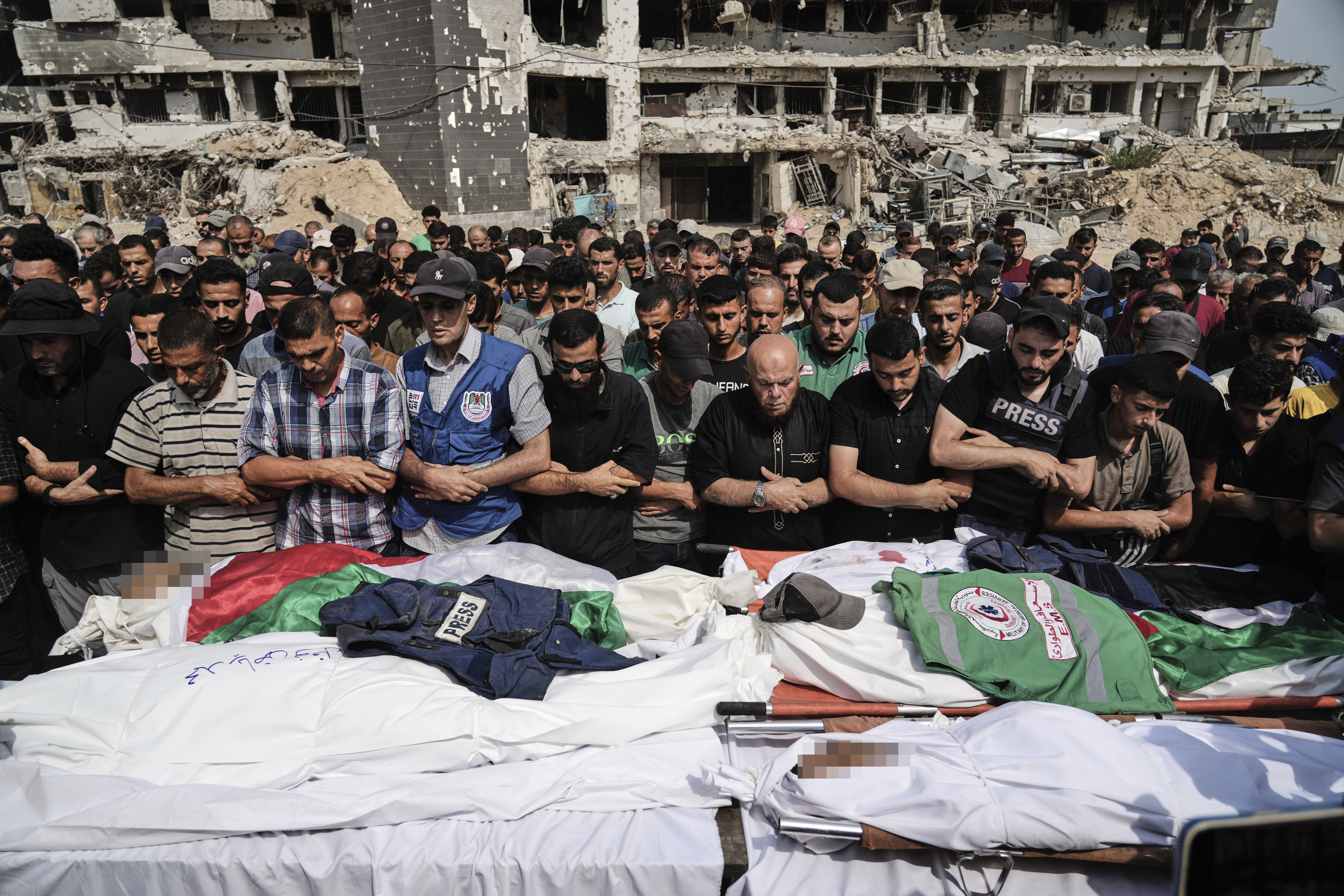 Palestinians gather in prayer over the bodies of journalists, including Al Jazeera correspondents Anas al-Sharif and Mohammed Qreiqeh, who were killed in a targeted Israeli air strike. The solemn funeral ceremony took place outside Gaza City&#039;s al-Shifa Hospital complex [Jehad Alshrafi/AP Photo]