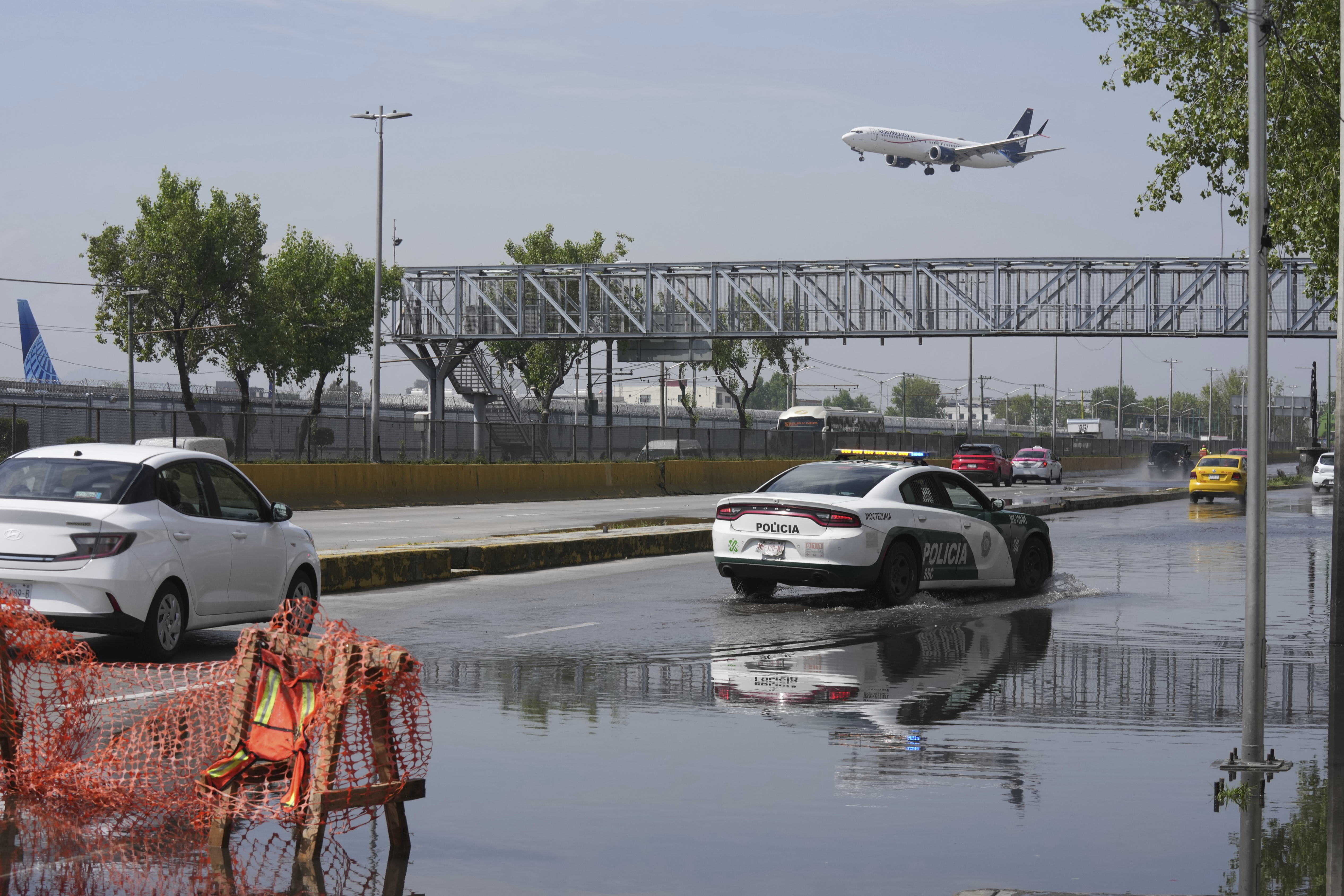 Drivers cross a flooded street just outside Benito Juarez International Airport in Mexico City, Mexico on August 12, 2025 [Fernando Llano/AP]