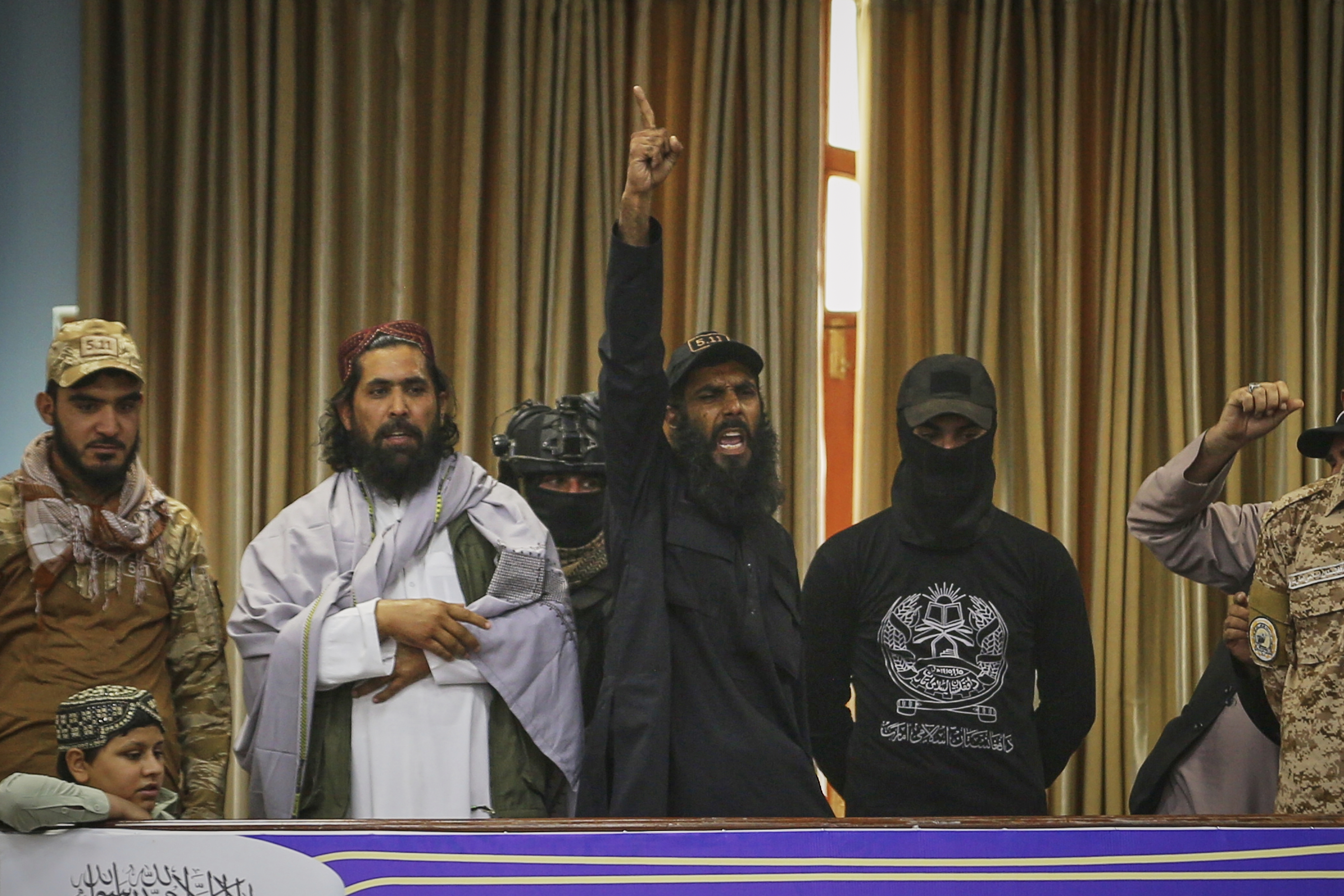 A man shouts praises to God and pro-Taliban slogans during a meeting of delegates that opens celebrations marking the fourth anniversary of the U.S. withdrawal and the start of Taliban rule, at Loya Jirga Hall in Kabul