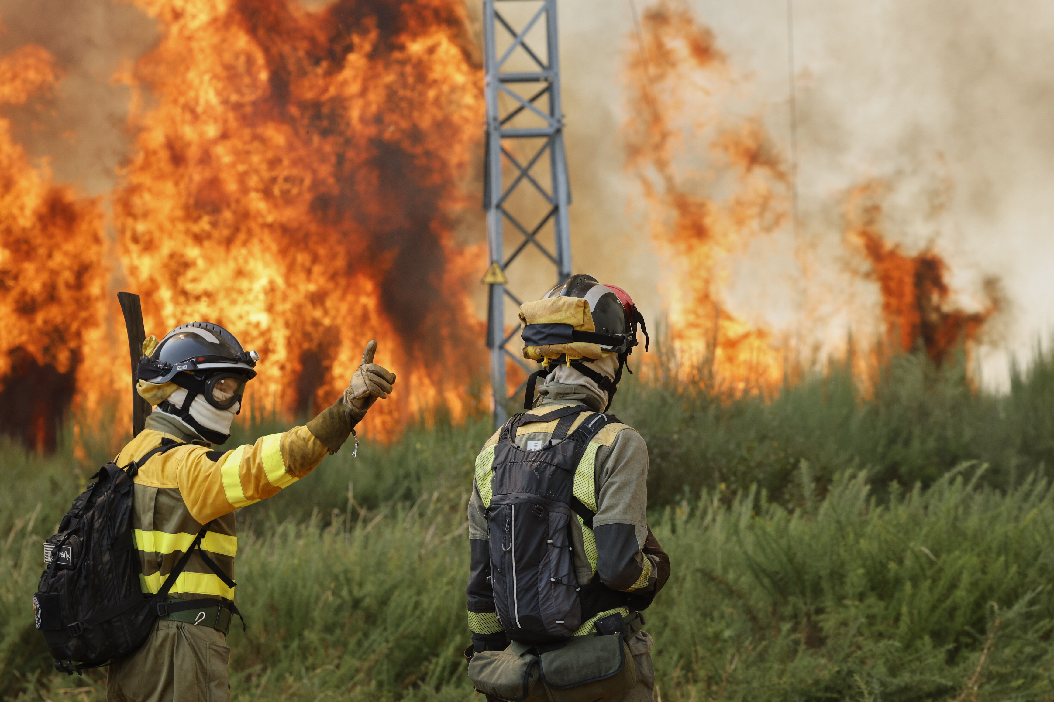 Firefighters battle a wildfire in Veiga das Meas, northwestern Spain on August 16, 2025.