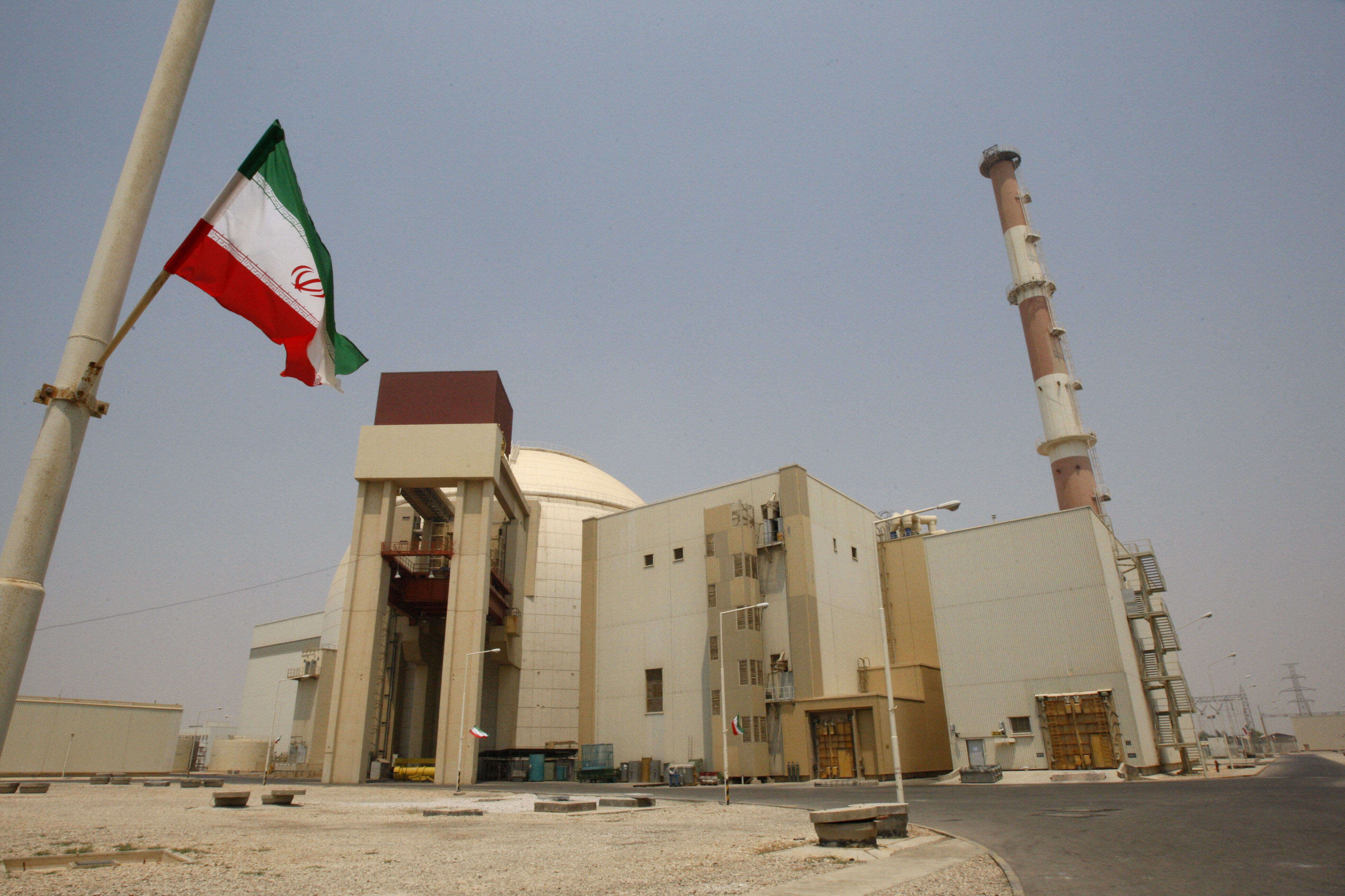 An Iranian flag flutters in front of the reactor building of the Bushehr nuclear power plant, just outside the southern city of Bushehr, Iran
