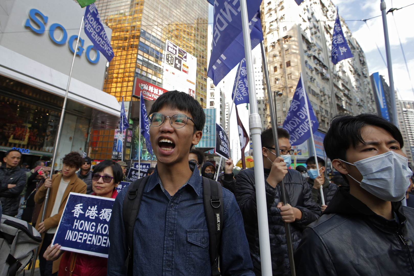 Pro-independence demonstrator Tony Chung, left, marches during an annual New Year protest in Hong Kong on Jan. 1, 2019. [Kin Cheung/AP]