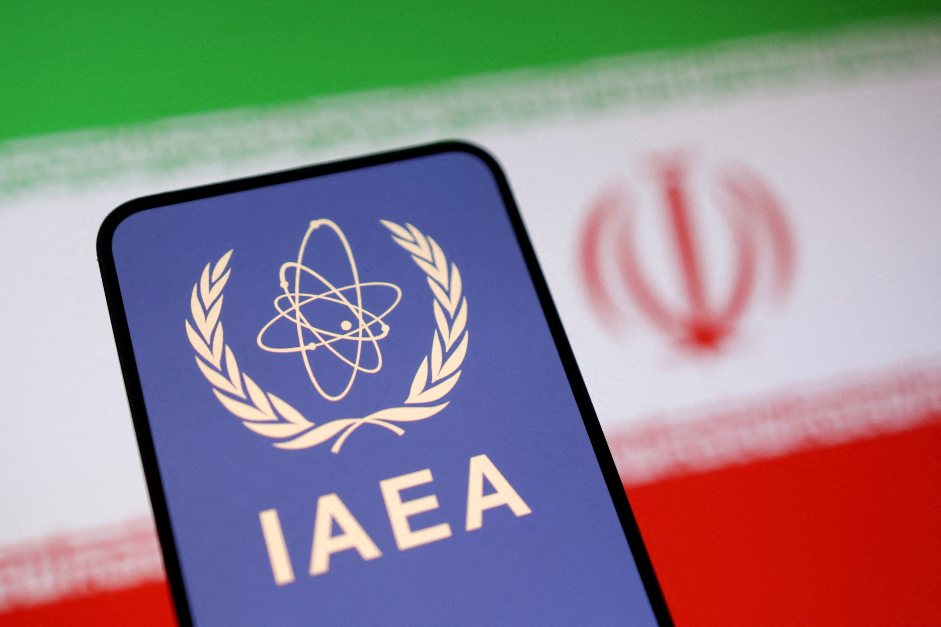 FILE PHOTO: International Atomic Energy Agency (IAEA) logo and Iranian flag is seen in this illustration taken June 16, 2025. REUTERS/Dado Ruvic/Illustration/File Photo