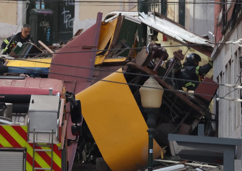 Police and firefighters work on the site of a funicular railway accident.