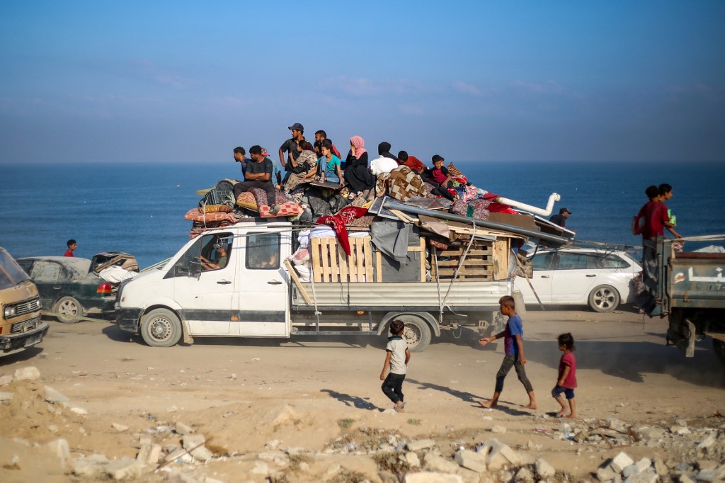 Displaced Palestinians move with their belongings southwards on a road in the Nuseirat refugee camp area in the central Gaza Strip following renewed Israeli evacuation orders for Gaza City on September 18, 2025. [Eyad Baba/ AFP]