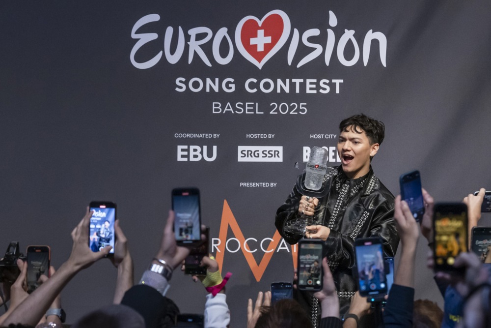 JJ, or Johannes Pietsch, of Austria gestures with the trophy during a news conference after winning the 2025 Eurovision Song Contest.