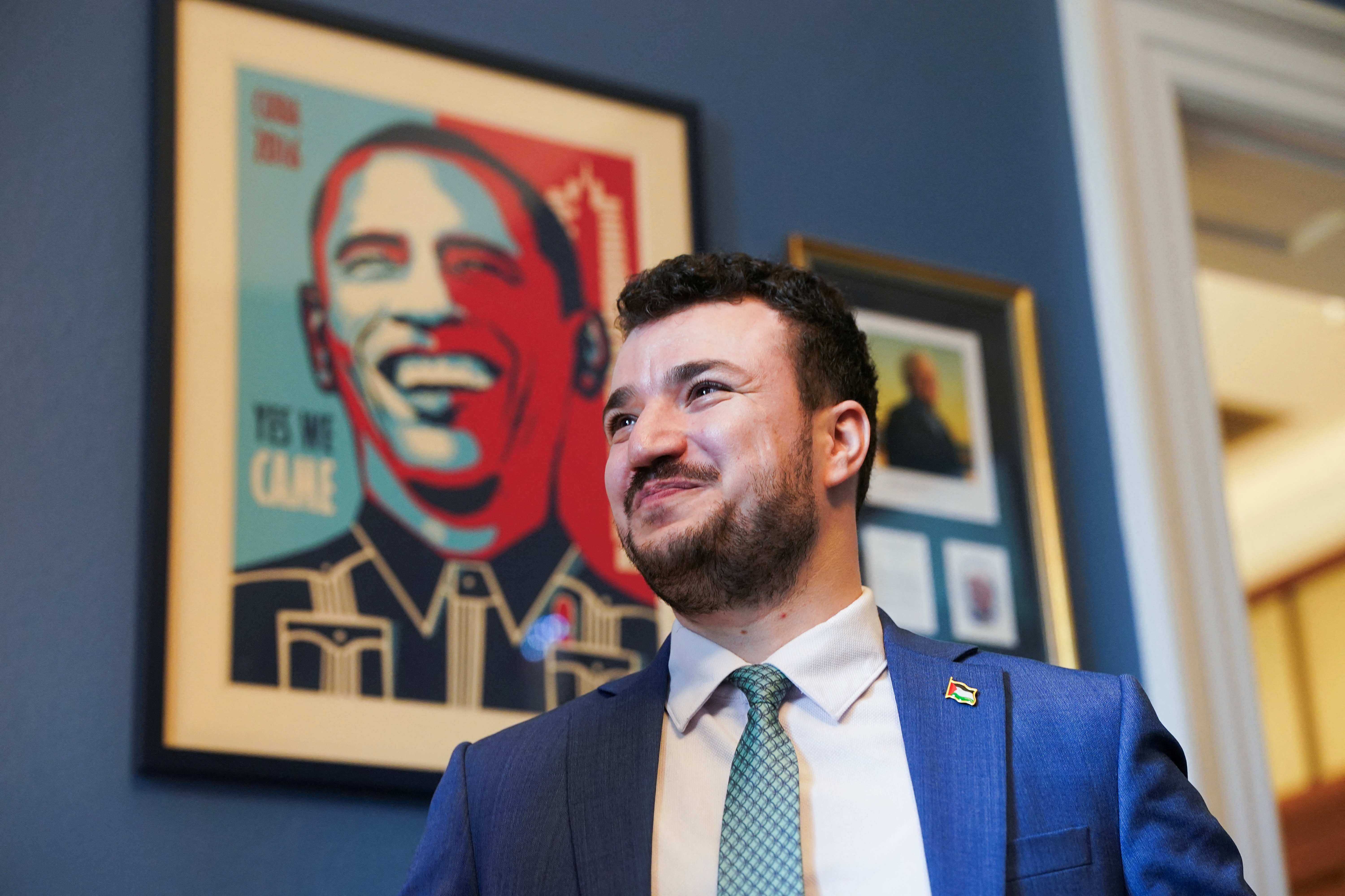 Columbia University graduate and pro-Palestinian activist Mahmoud Khalil stands in front of an image depicting former U.S. President Barack Obama, as he meets with U.S. Representative Jim McGovern (D-MA) (not pictured), during Khalil's visit to Capitol Hill in Washington, D.C., U.S., July 22, 2025. REUTERS/Nathan Howard