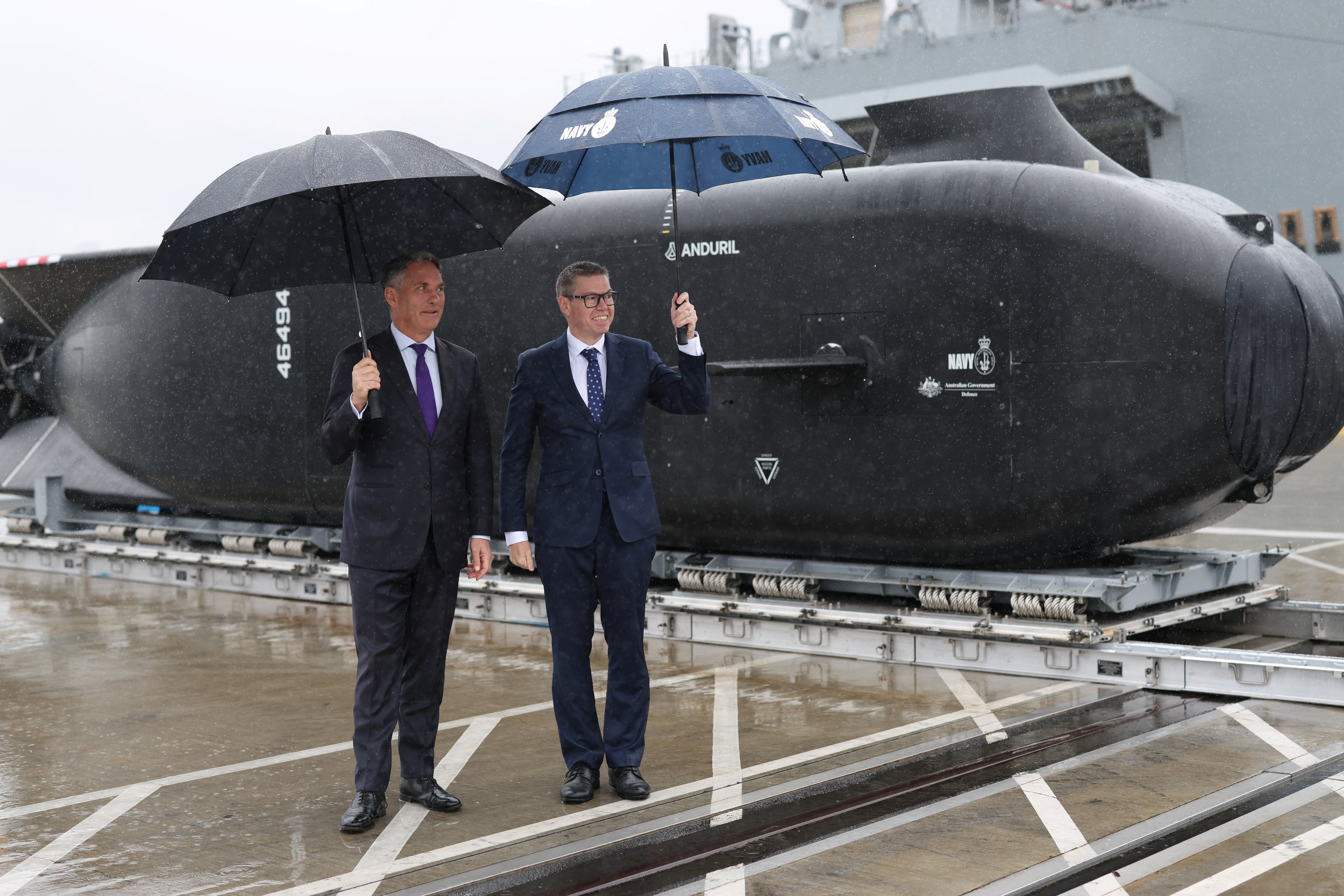 Richard Marles, Australian Deputy Prime Minister and Minister for Defence, and Pat Conroy, Australian Minister for Defence Industry, pose beside an Anduril Ghost Shark Extra Large Autonomous Undersea Vehicle (XL-AUV) displayed at the Royal Australian Navy base HMAS Kuttabul, in Sydney, Australia, September 10, 2025. REUTERS/Hollie Adams