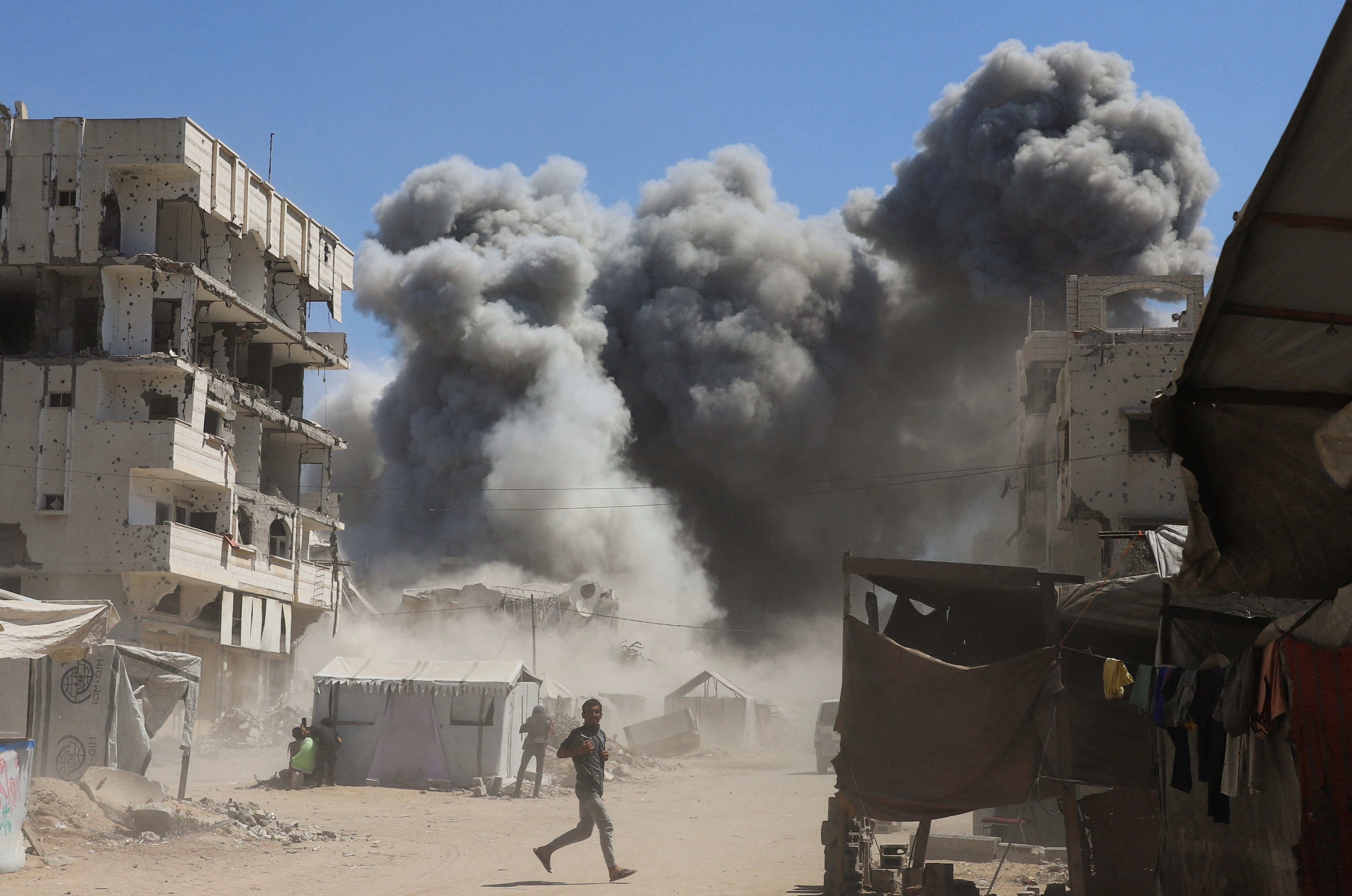 Smoke rises from a residential building that was housing displaced Palestinians, after it was hit by an Israeli air strike, in Gaza City, September 14, 2025 [Ebrahim Hajjaj/Reuters]