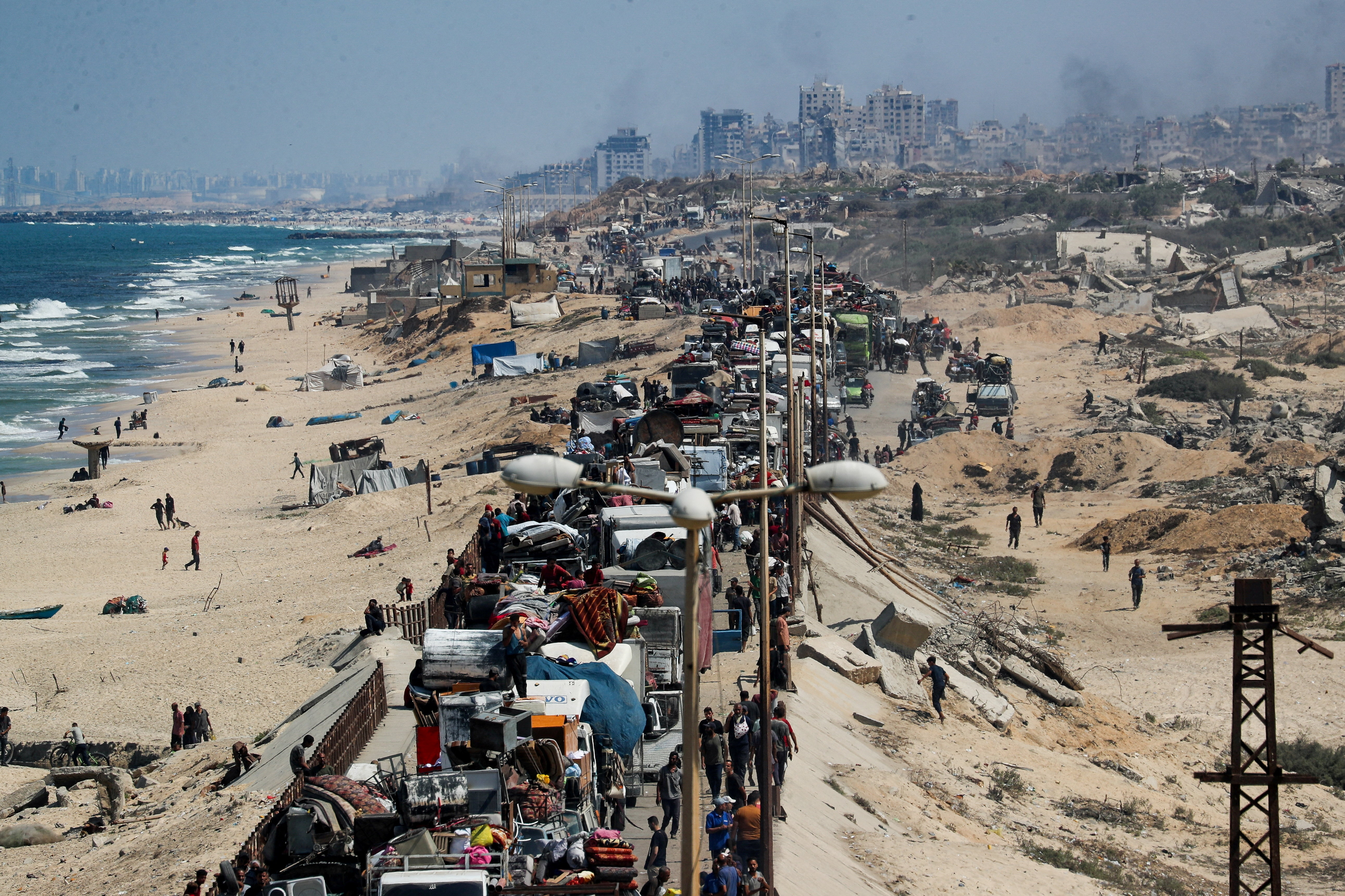 Displaced Palestinians head southwards through the central Gaza Strip after fleeing the north amid an Israeli military operation