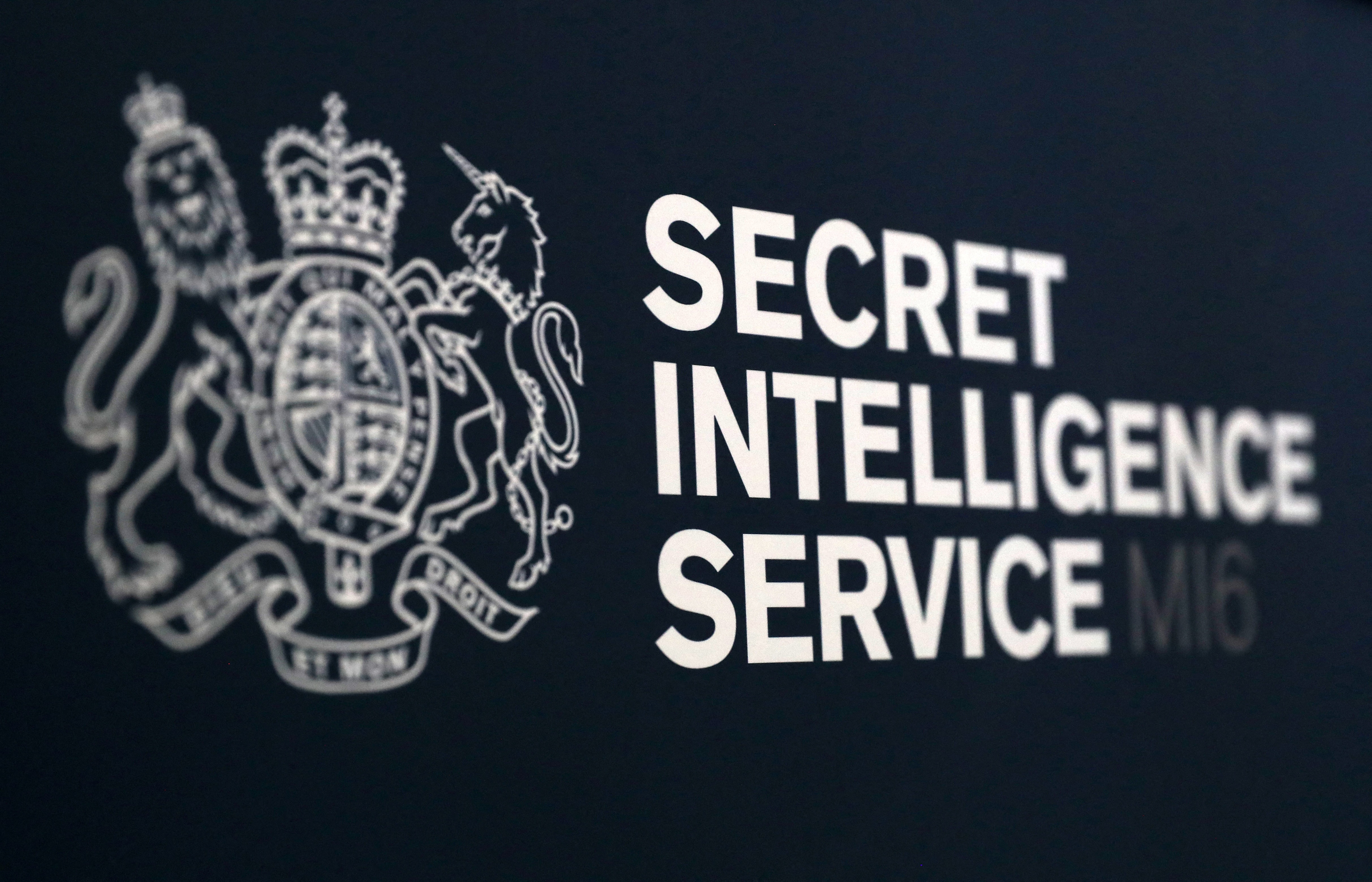 A Secret Intelligence Service (MI6) logo is pictured ahead of a speech by Alex Younger, incoming head of Britain's MI6 foreign intelligence agency, at the University of St Andrews in Str Andrews, east Scotland on December 3, 2018. Britain's MI6 foreign intelligence agency on Friday announced Alex Younger had been appointed as the new 'C', the head of the spy service, and will take up his appointment next month. (Photo by Andrew Milligan / POOL / AFP)