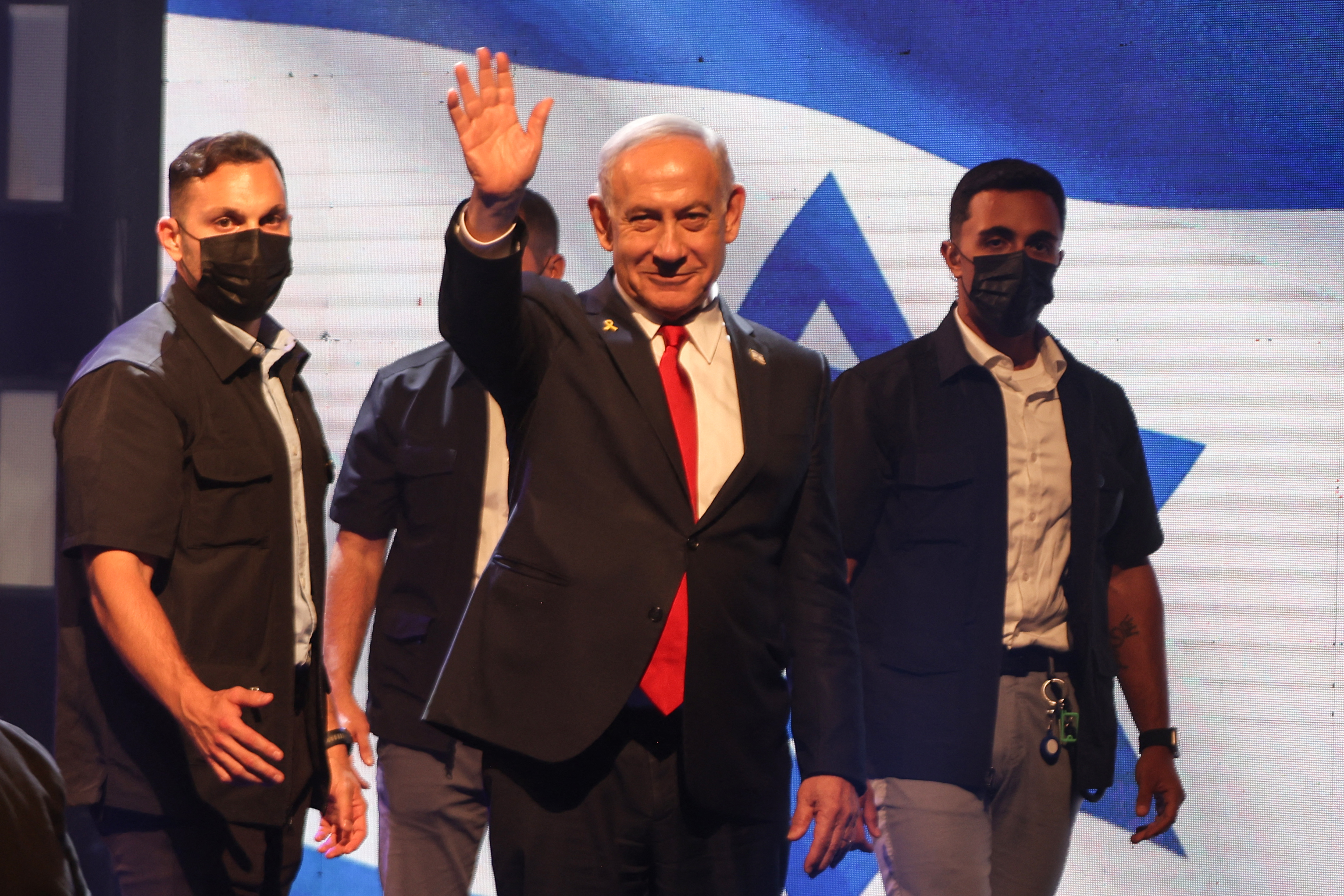 Israeli Prime Minister Benjamin Netanyahu waves as he arrives to attend a signing ceremony for a framework agreement aiming to speed up development in the Israeli settlement of Maale Adumim, in the occupied West Bank, on September 11, 2025 [Menahem Kahana/AFP]