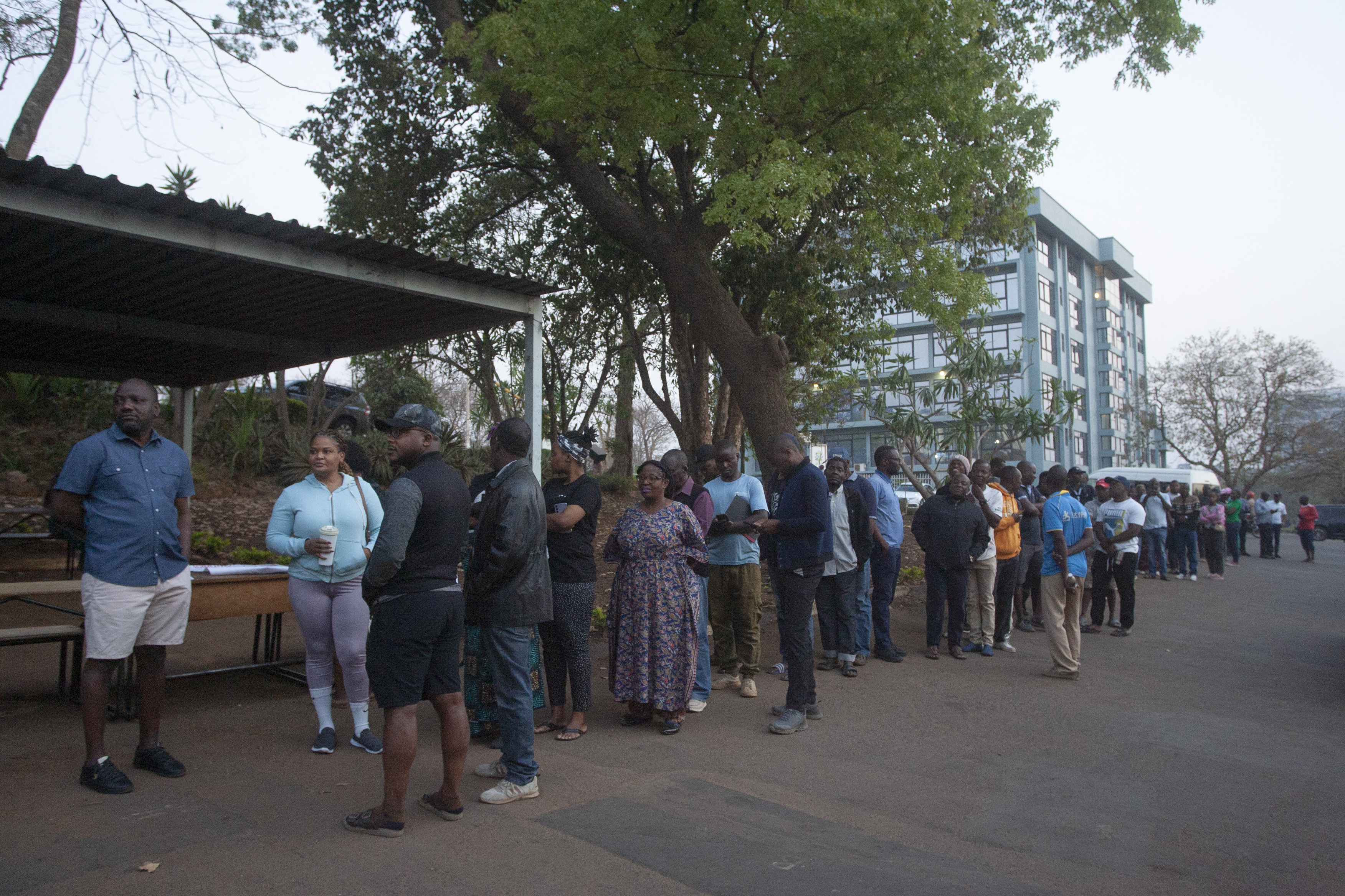 Voters queue at a polling station.