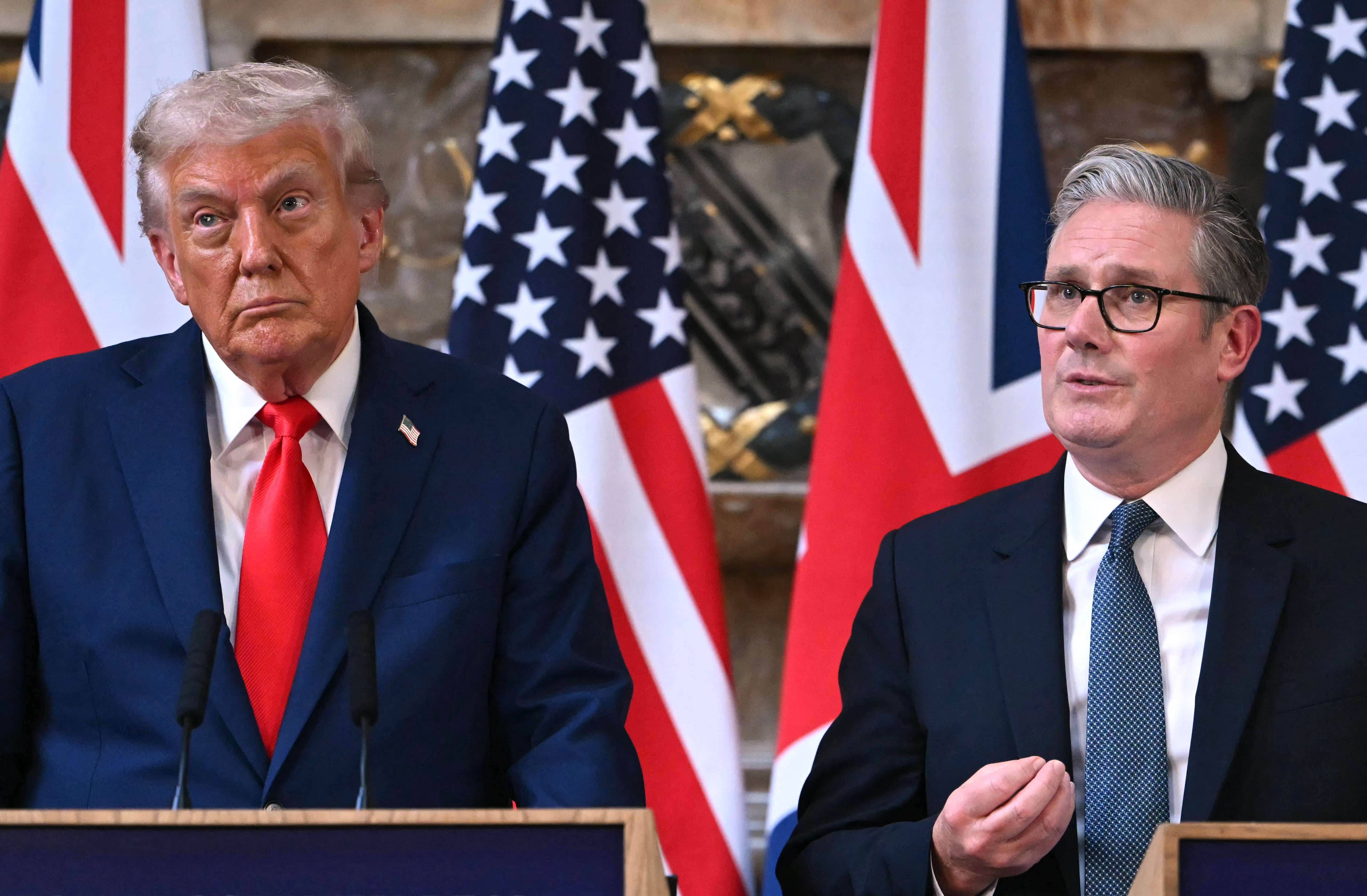 Britain's Prime Minister Keir Starmer (R) speaks as US President Donald Trump
