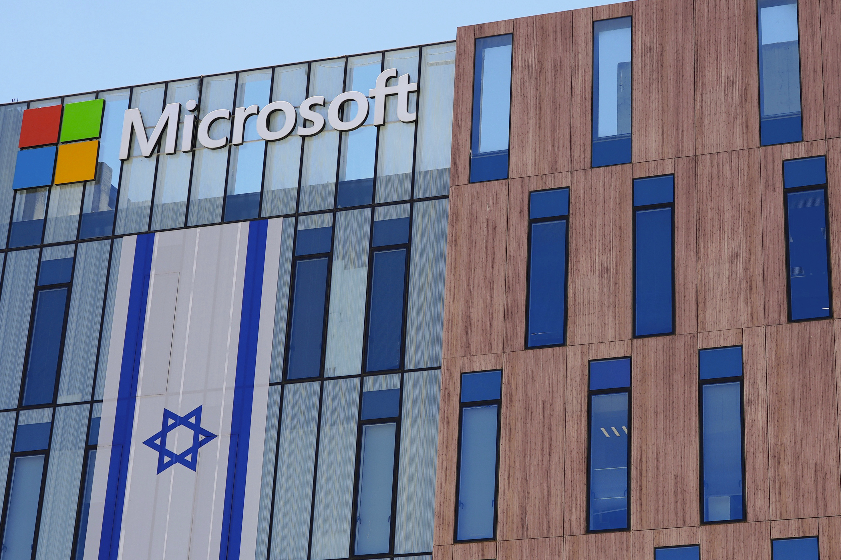 An Israeli flag is draped over the Microsoft offices in a building in Israel.