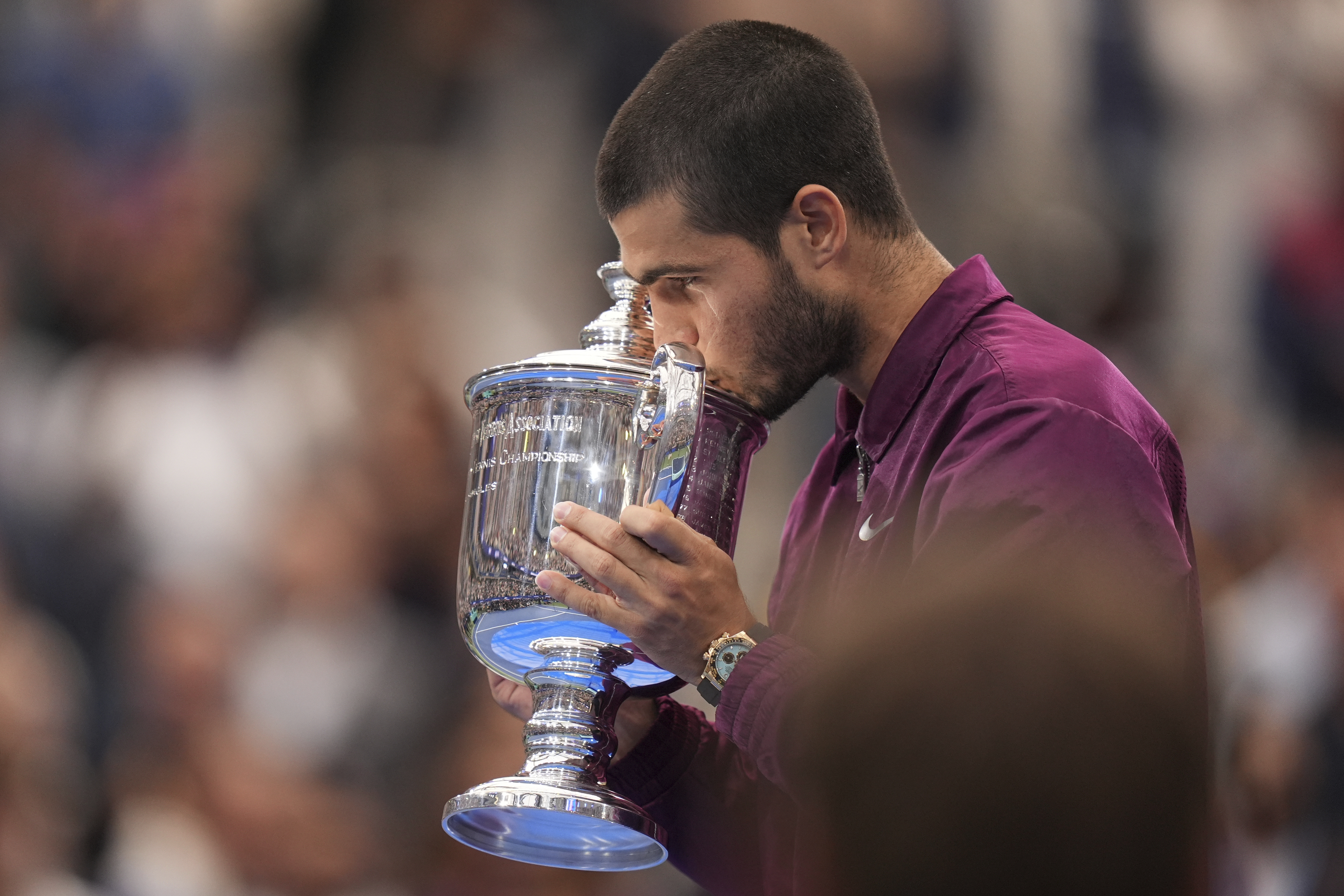 Carlos Alcaraz, of Spain, kisses the championship trophy after defeating Jannik Sinner, of Italy, in the men's singles final of the U.S. Open tennis championships, Sunday, Sept. 7, 2025, in New York. (AP Photo/Seth Wenig)