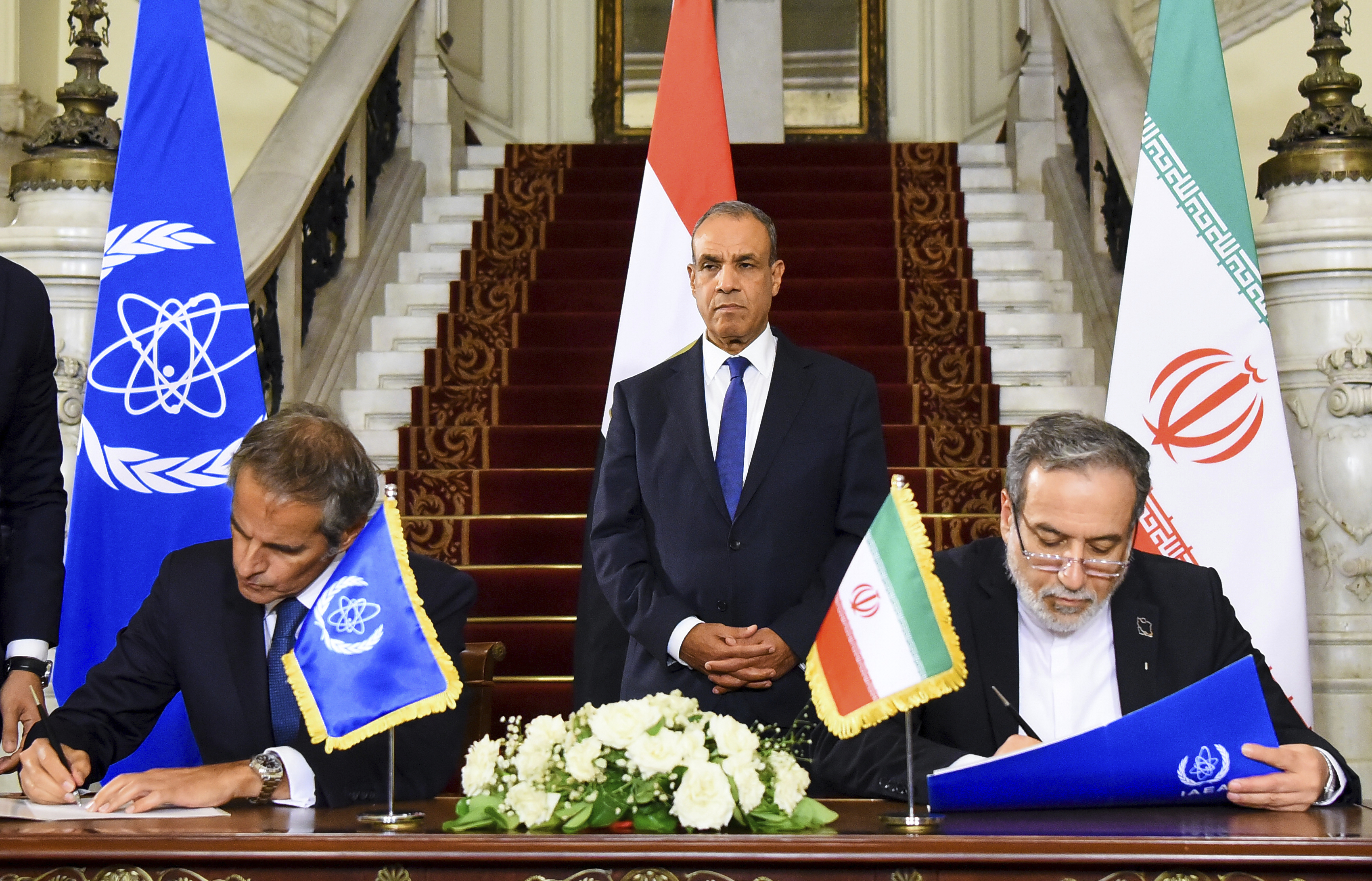 Iranian Foreign Minister Abbas Araghchi, right, and Director General of the IAEA, Rafael Grossi, left, sign an agreement to open the way for resuming cooperation, at Tahrir Palace in Cairo, Egypt, on September 9, 2025 [Egyptian Foreign Ministry Press Service via AP]