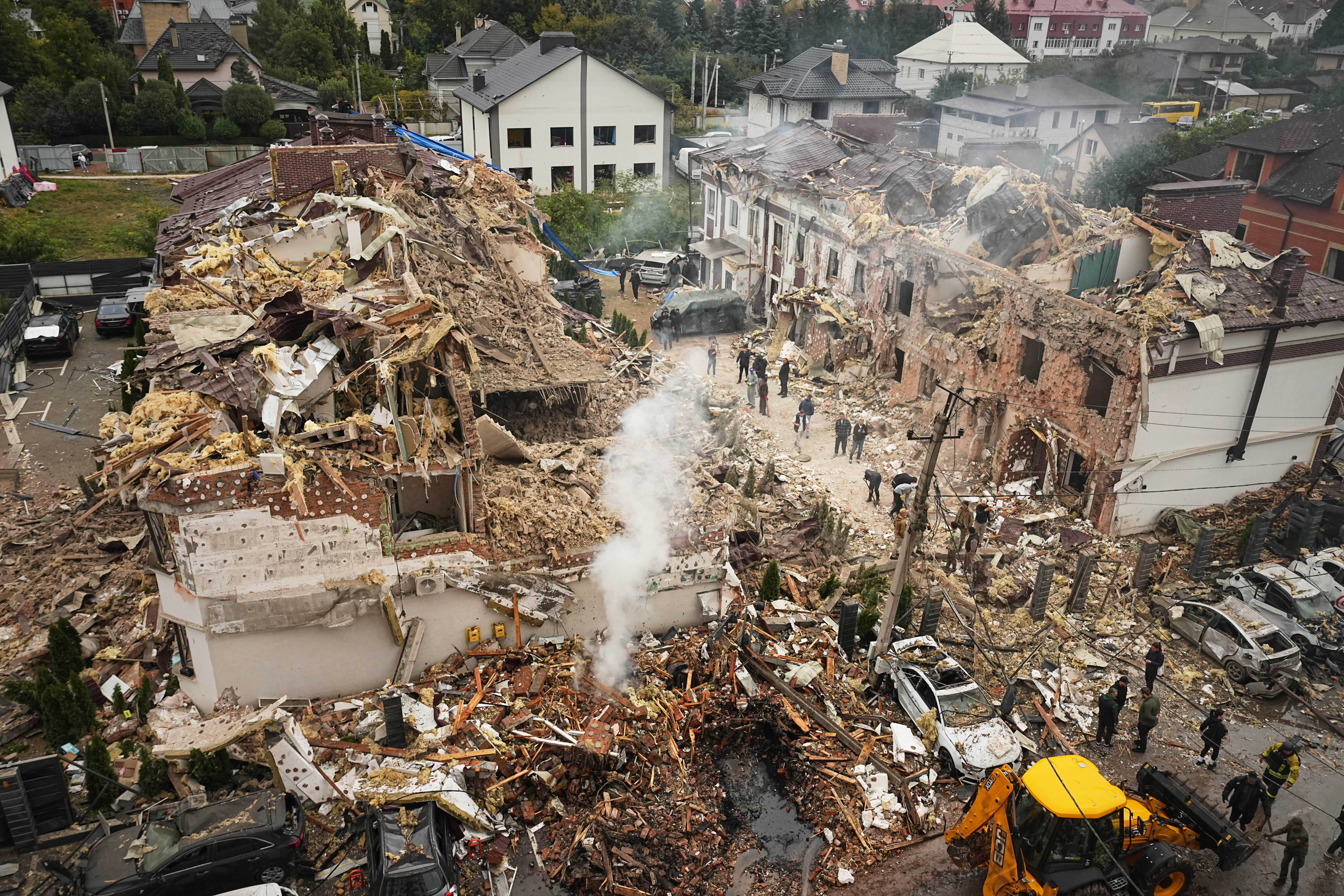 Rescuers work at the site of apartment buildings damaged during a Russian attack in Kyiv, Ukraine. [Efrem Lukatsky/AP Photo]