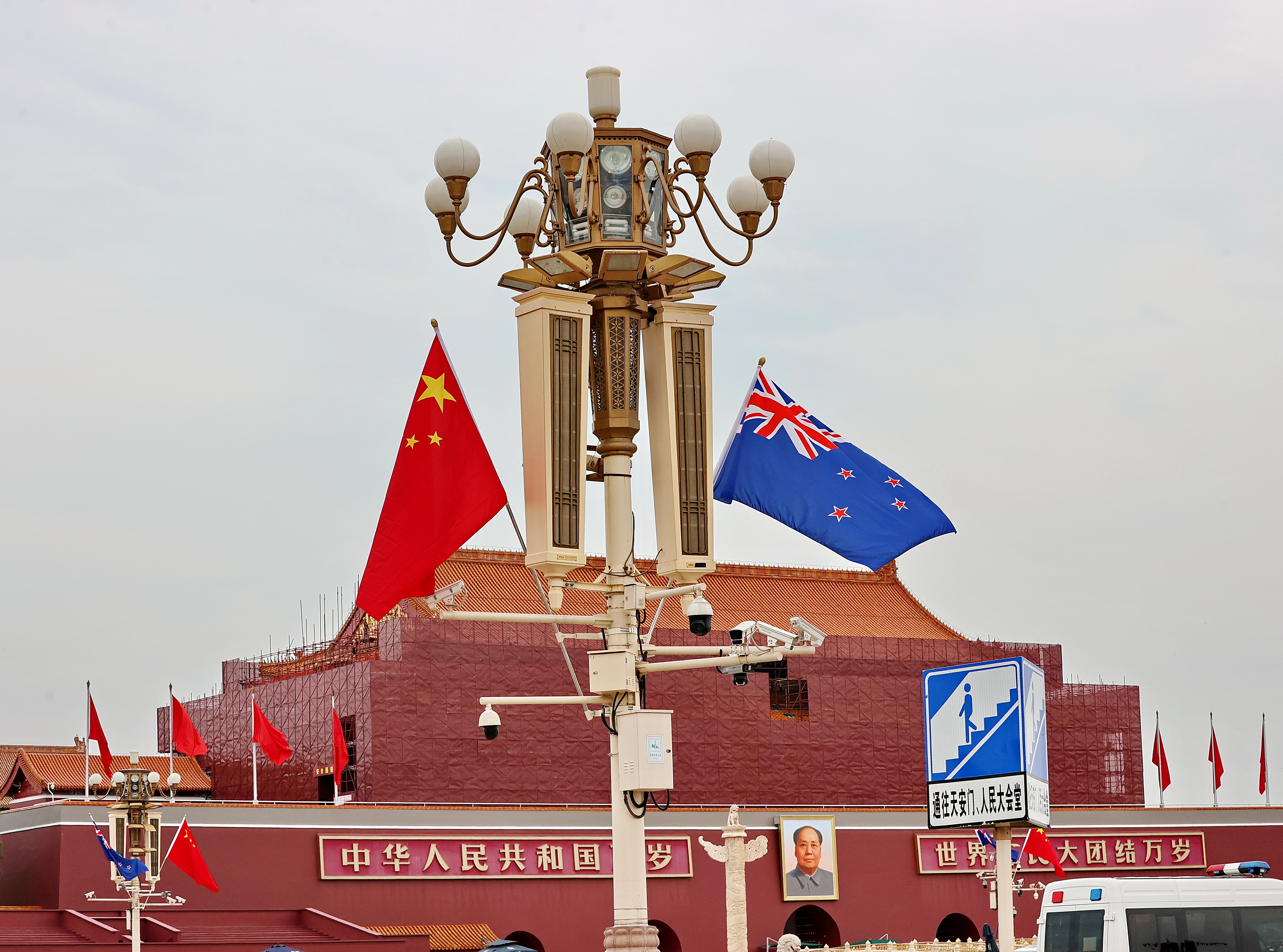 The national flags of China and New Zealand flutter at Tiananmen Square in Beijing.