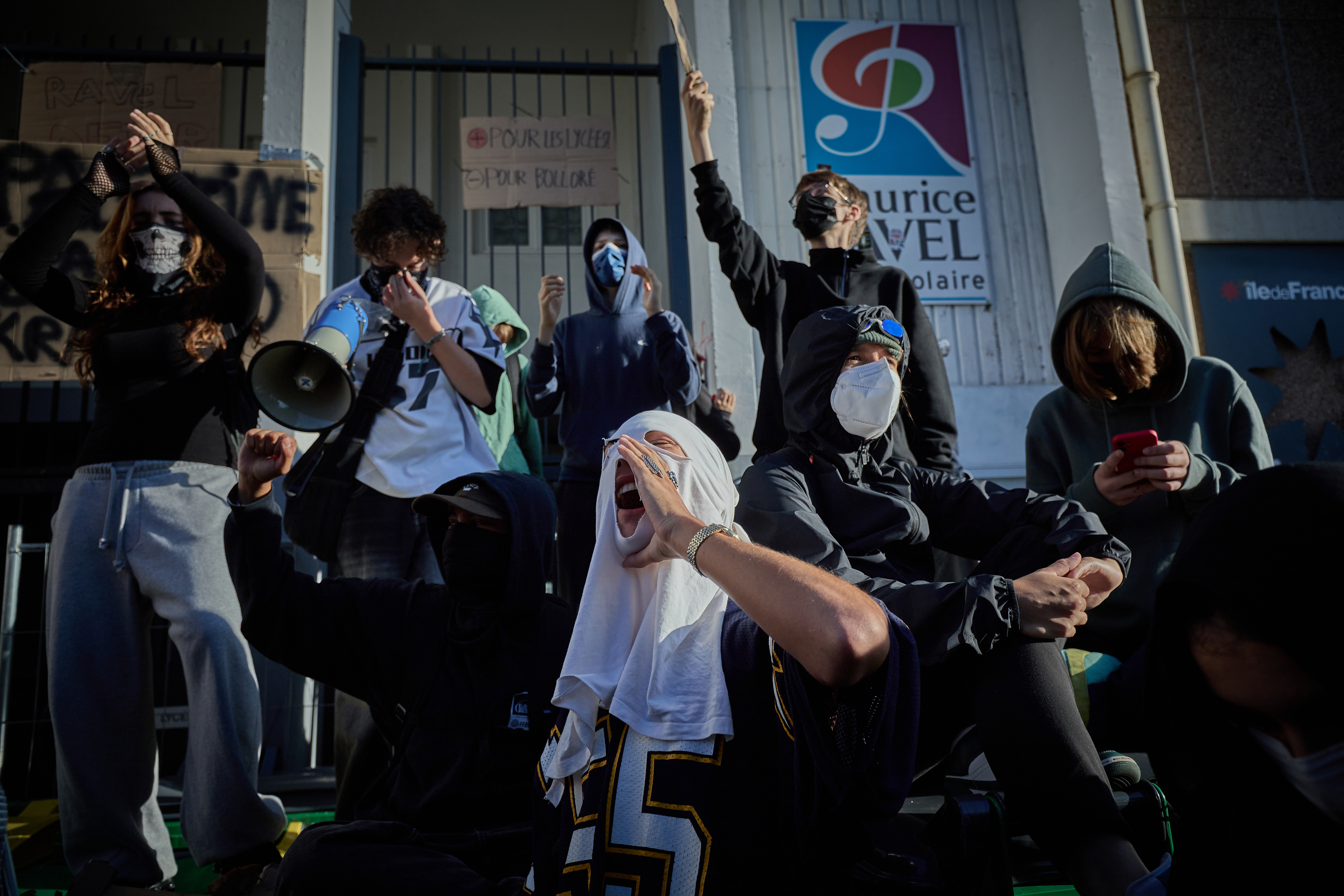 French students chant as they block the entrance to Maurice-Ravel School as part of a nationwide day of protests and strikes against budget reforms on September 18, 2025 in Paris, France [Kiran Ridley/Getty Images]